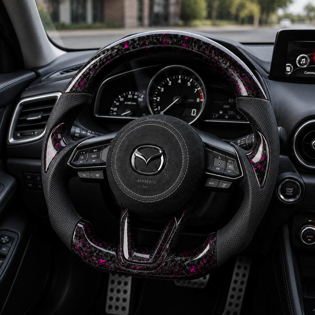 Custom Mazda 3 Axela forged carbon steering wheel installed in car interior with magenta accents black perforated leather grips and suede airbag cover