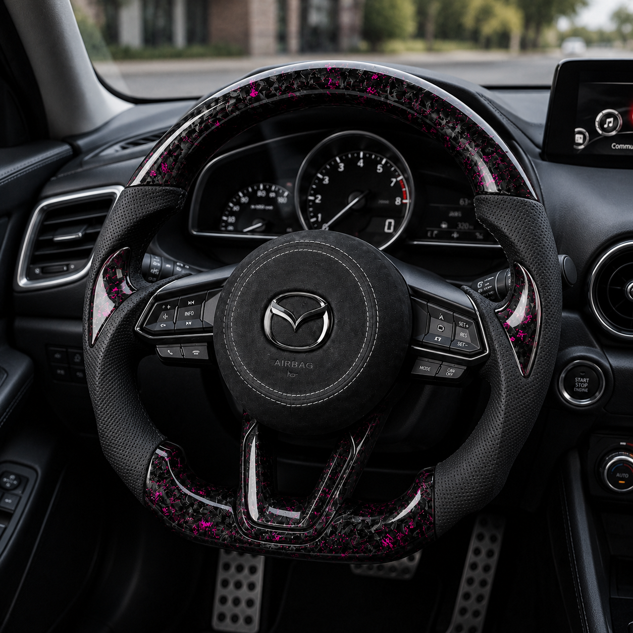 Custom Mazda 3 Axela forged carbon steering wheel installed in car interior with magenta accents black perforated leather grips and suede airbag cover