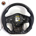Toyota Supra A90 performance steering wheel in forged carbon composite with perforated leather side grips and handcrafted turquoise stitching by CJ Mod Garage