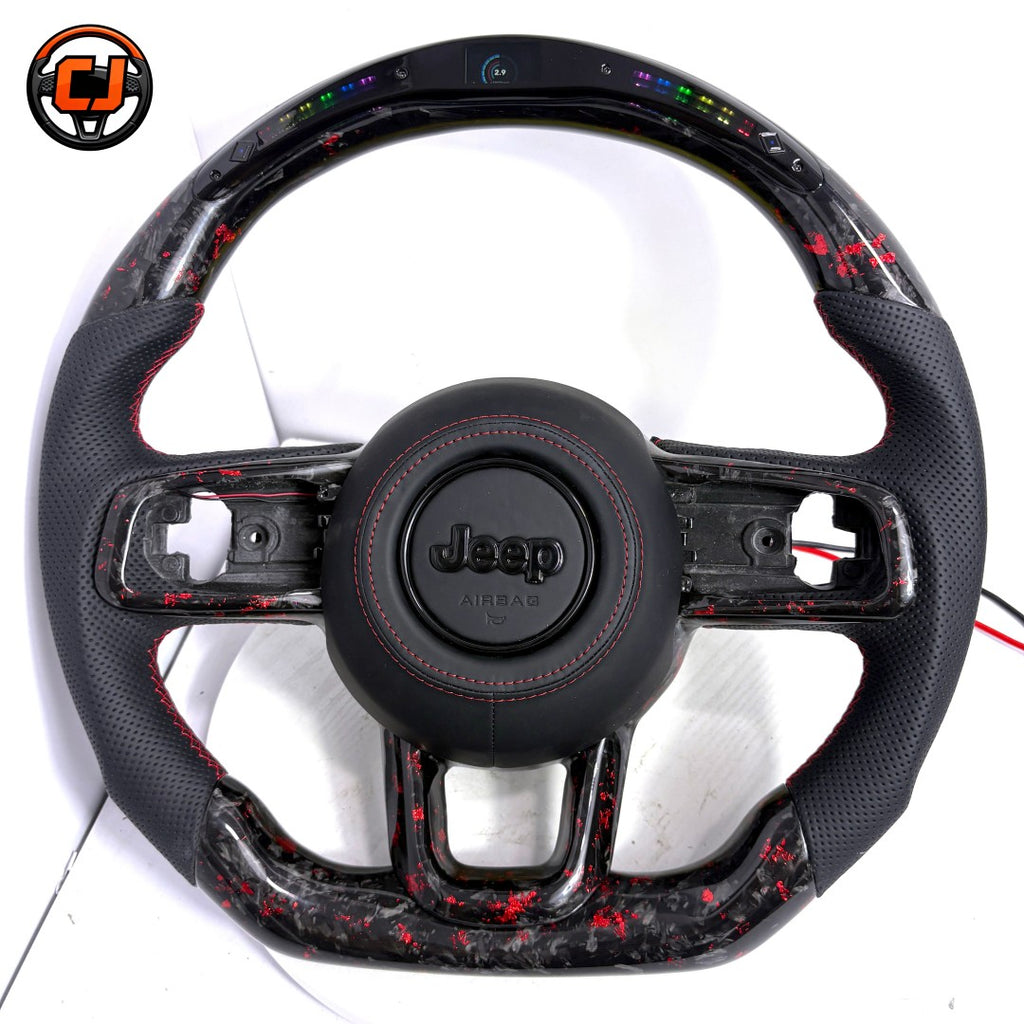 Studio front view of custom Jeep Wrangler LED carbon fiber steering wheel with black perforated leather grips, red stitching, black Jeep airbag cover, exposed button openings and red flake carbon fiber trim