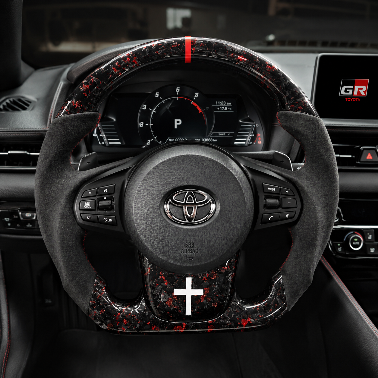 Toyota GR Supra A90 A91 forged carbon steering wheel with red flake carbon fiber, Alcantara side grips and red center marker installed in cockpit by CJ Mod Garage