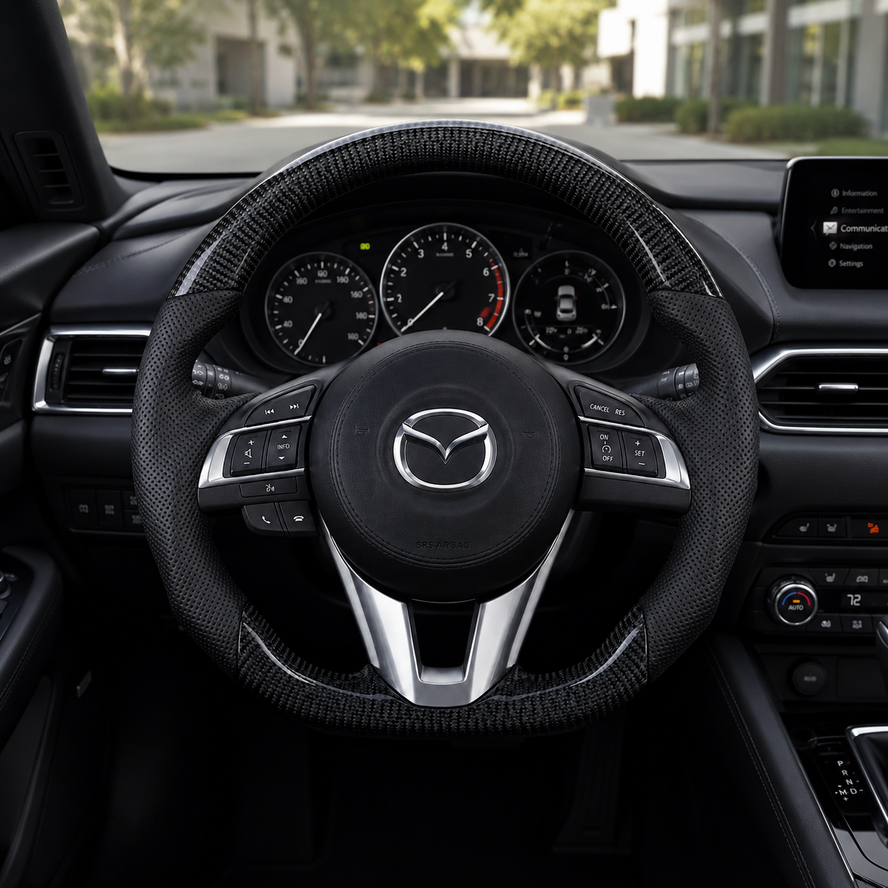 Custom Mazda steering wheel in car interior with glossy carbon fiber sections black perforated leather grips and OEM style controls
