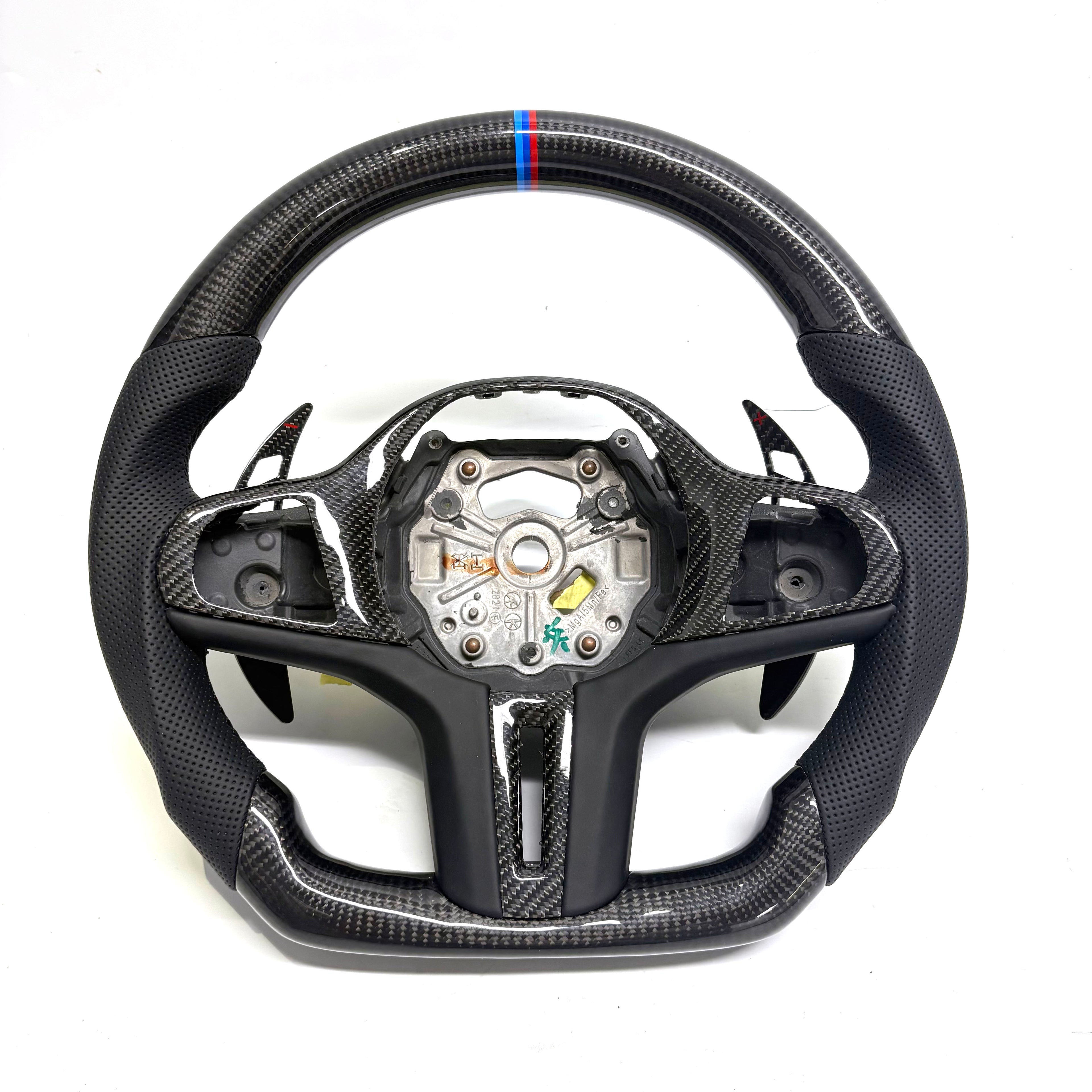 CJ Mod Garage BMW custom carbon fiber steering wheel on white background featuring gloss carbon fiber top and bottom, black perforated leather grips, M tricolor 12 o’clock stripe, flat-bottom sport design, and OEM-style fitment compatible with BMW G02 G05 G06 G09 G11 G12 G15 G20 G22 G28 G29 G30 G38 G80 G82 F40 F90