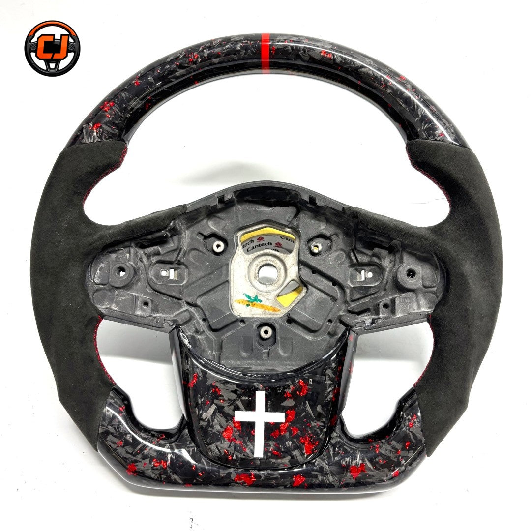 Toyota GR Supra A90 performance steering wheel in forged carbon composite with red flake finish, Alcantara leather grips and handcrafted racing-inspired design by CJ Mod Garage