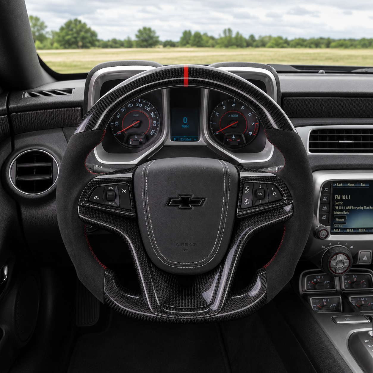 Custom Chevrolet Camaro steering wheel installed in vehicle interior red and black design carbon fiber trim and dashboard display
