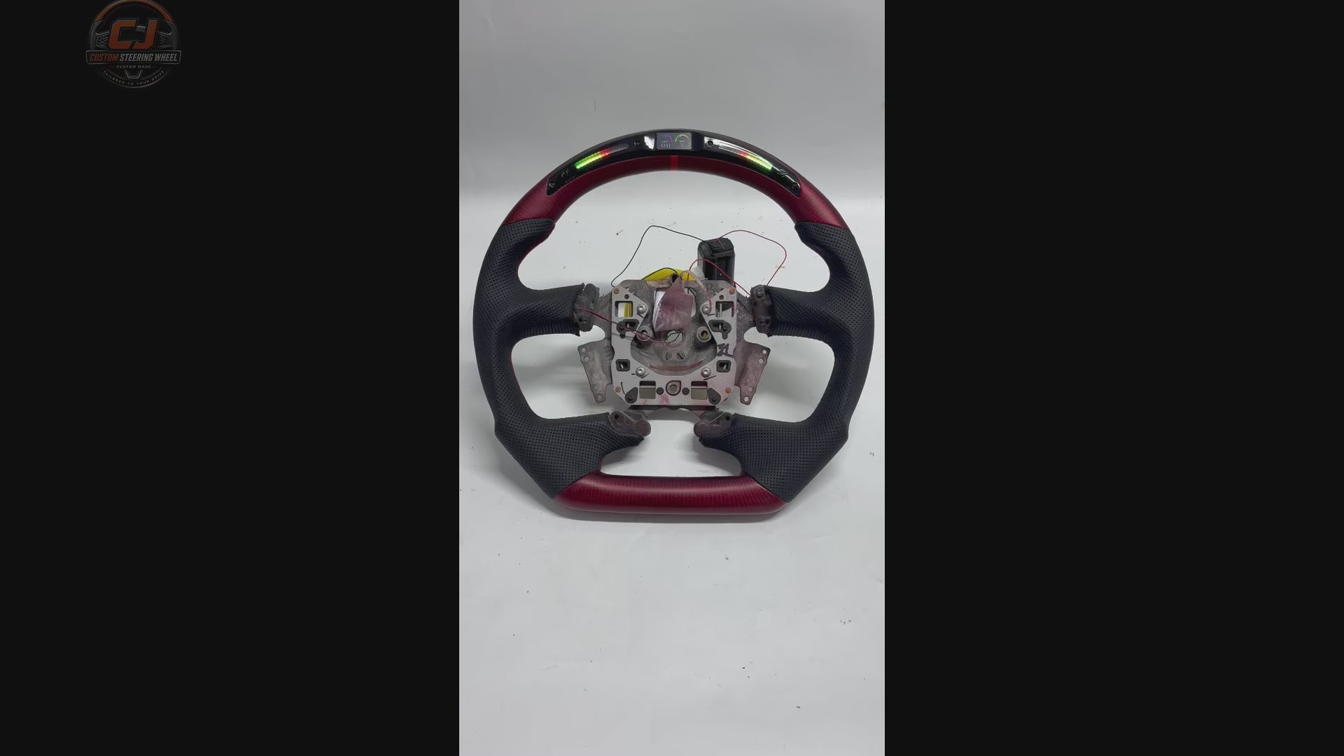 White background video of Ford Falcon FG XR XR6 XR8 steering wheel with LED display red carbon fiber and black perforated leather by CJ Mod Garage
