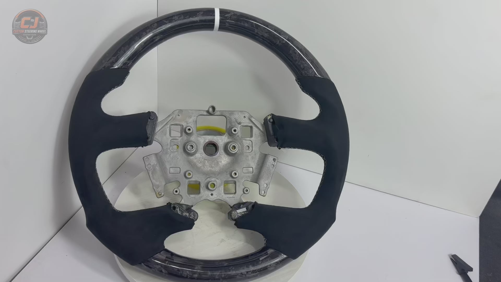 Ford Falcon FG XR XR6 XR8 forged carbon and black Alcantara custom steering wheel product video on white background by CJ Mod Garage