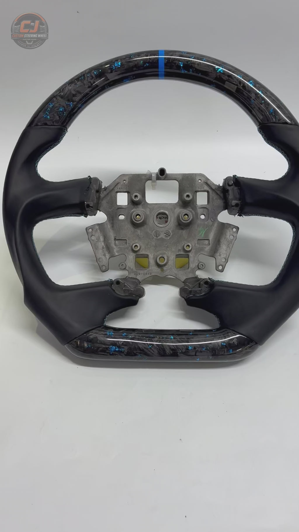 White background product video of Ford Falcon FG XR XR6 XR8 custom steering wheel in blue flake forged carbon blue center stripe and smooth black leather by CJ Mod Garage