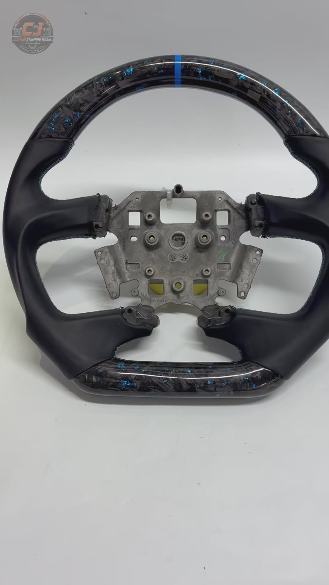 White background product video of Ford Falcon FG XR XR6 XR8 custom steering wheel in blue flake forged carbon blue center stripe and smooth black leather by CJ Mod Garage