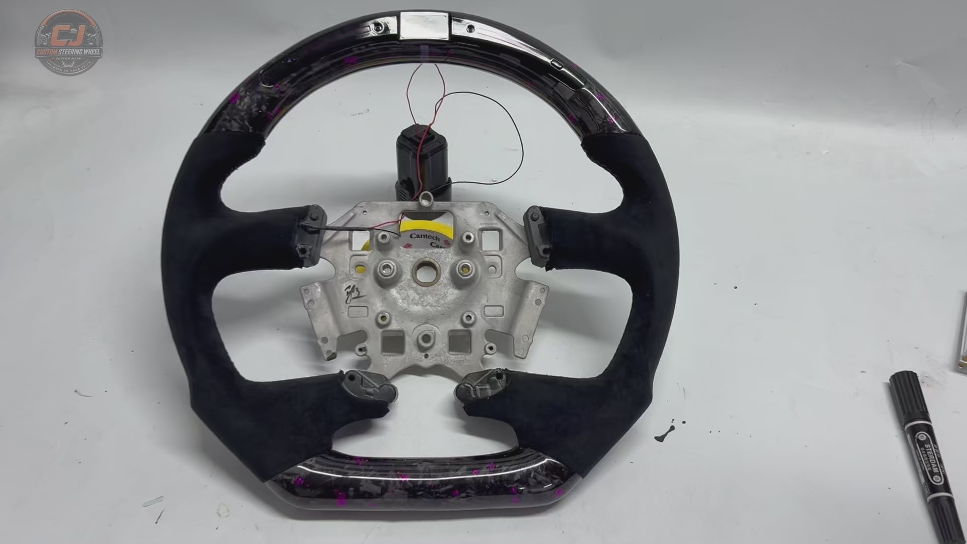 White background product video of Ford Falcon FG XR XR6 XR8 custom steering wheel in LED purple forged carbon and black suede grips by CJ Mod Garage