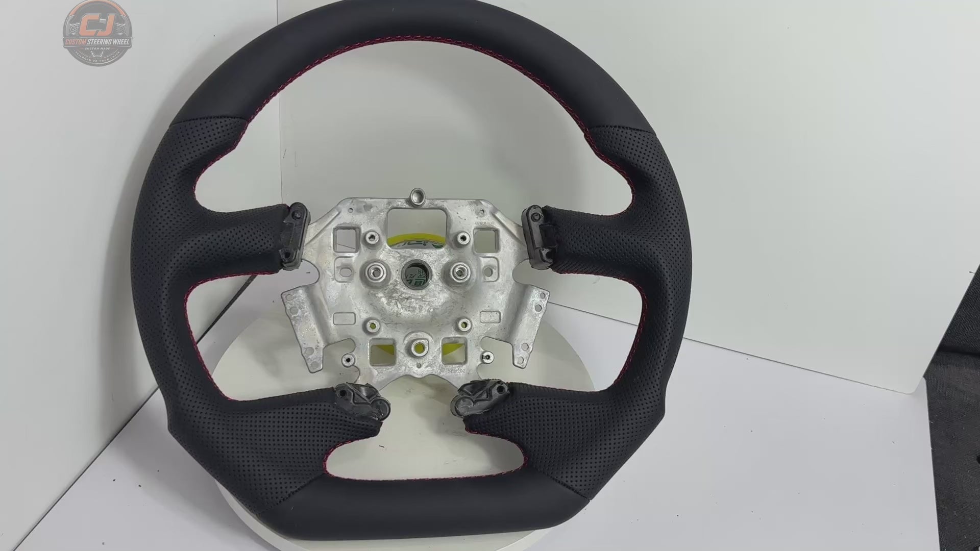 White background product video of Ford Falcon FG XR XR6 XR8 custom steering wheel in smooth black leather and perforated side grips by CJ Mod Garage