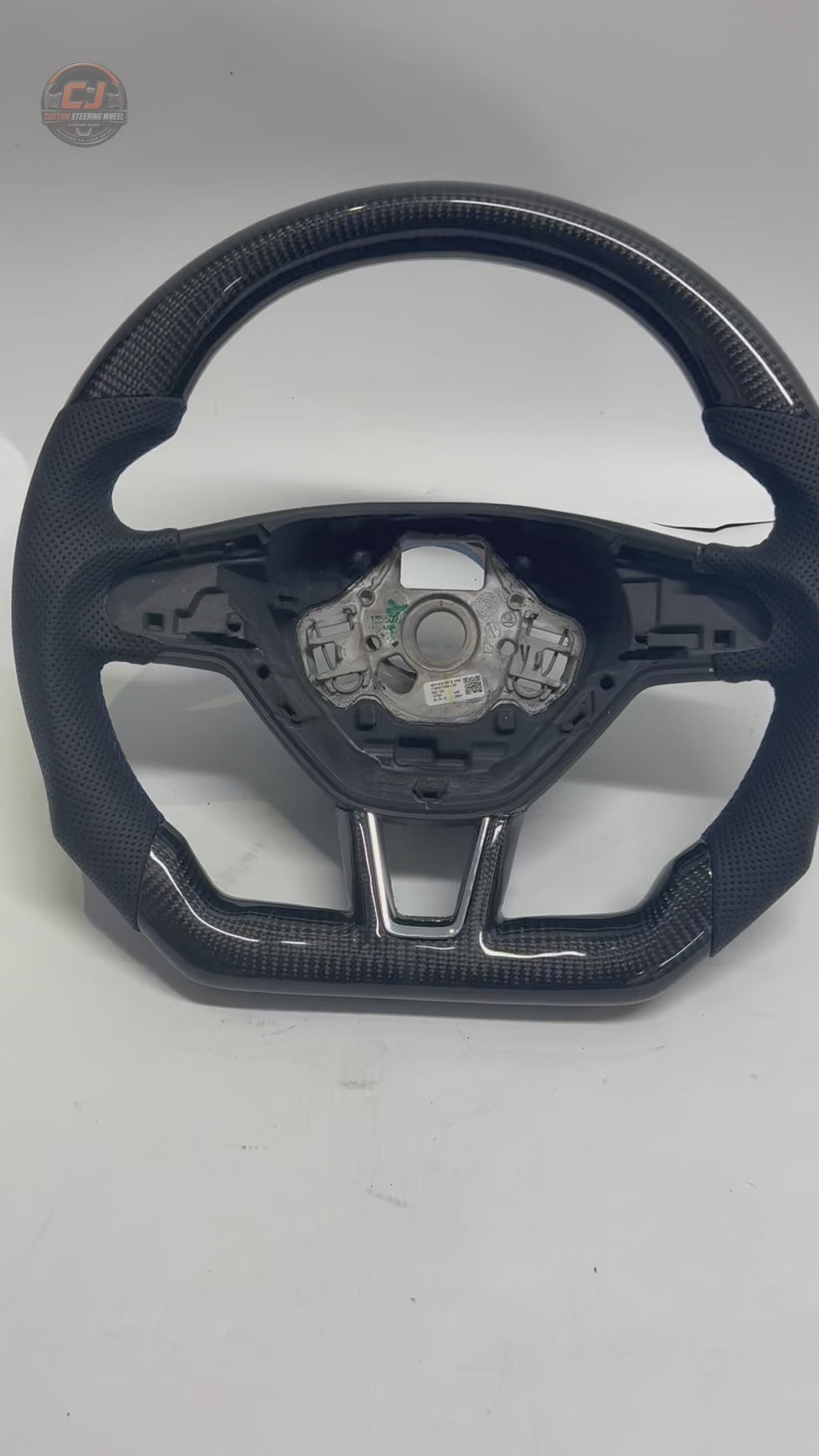 Product showcase video displaying custom Skoda carbon fiber steering wheel with perforated leather grip flat bottom structure and performance inspired styling for Octavia 2014 2020 Superb 2015 2023 Karoq 2018 2024 by CJ Mod Garage