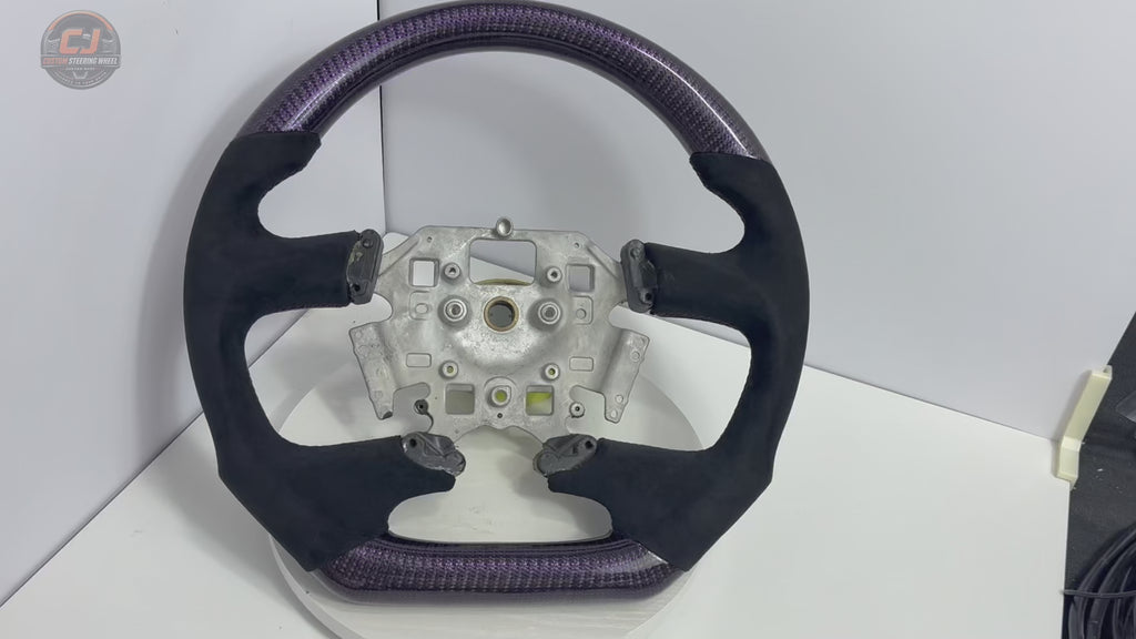 White background product video of Ford Falcon FG XR XR6 XR8 custom steering wheel in purple carbon fiber and black suede grips by CJ Mod Garage