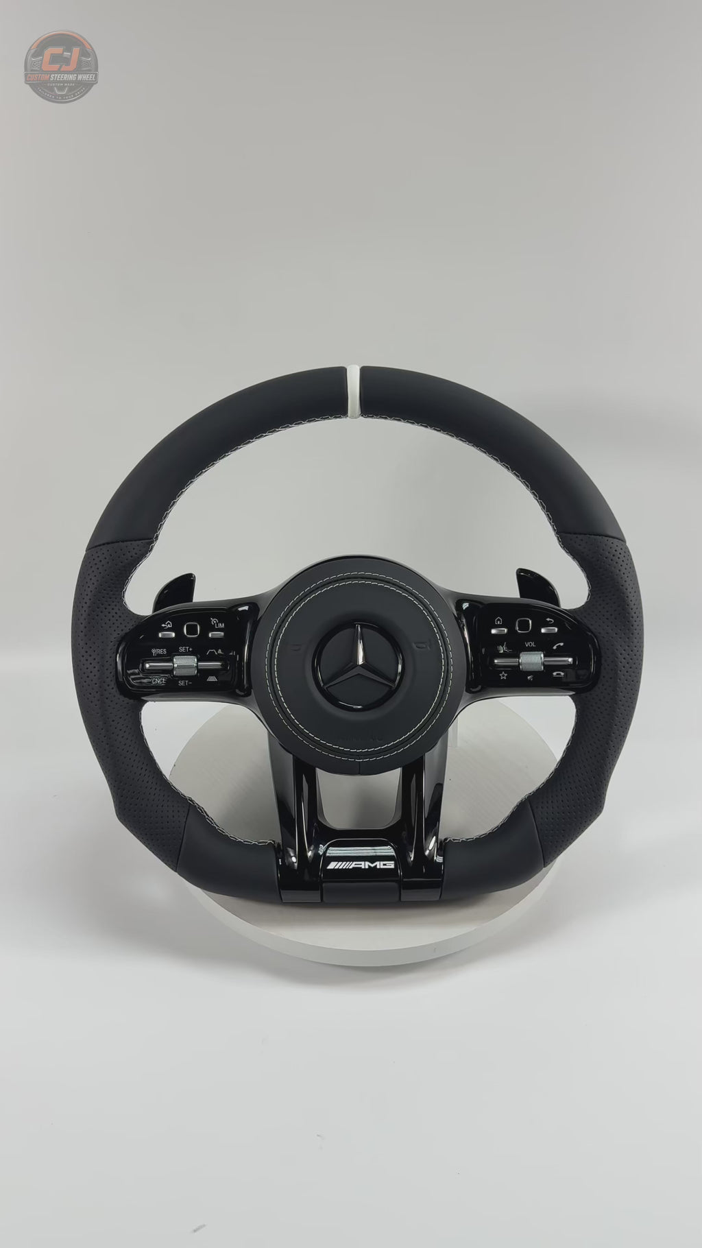 White background Mercedes AMG steering wheel video showing smooth black leather white stitching and sport grip design for W117 W176 W177 W203 W204 W205 W211 W212 W213 W218 C43 C63 C200 C300 CJ Mod Garage