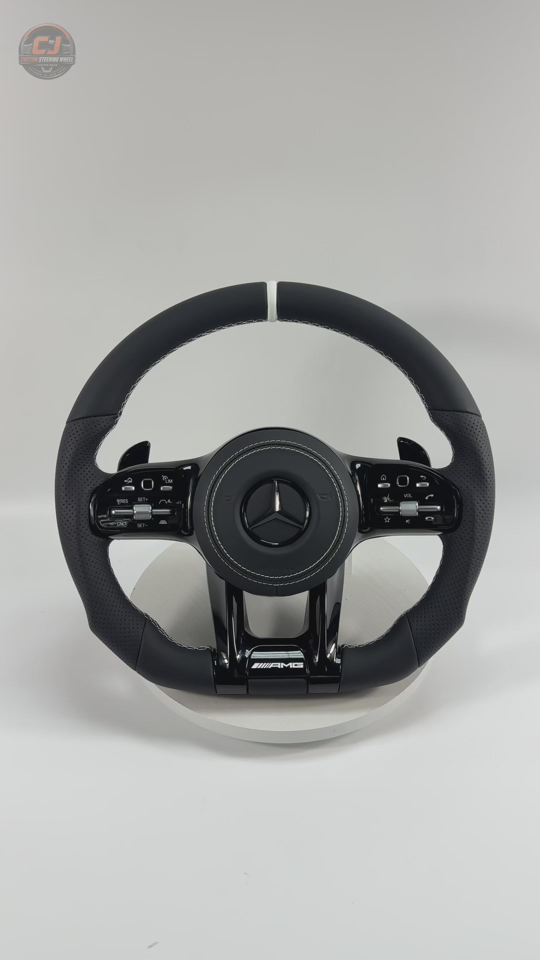 White background Mercedes AMG steering wheel video showing smooth black leather white stitching and sport grip design for W117 W176 W177 W203 W204 W205 W211 W212 W213 W218 C43 C63 C200 C300 CJ Mod Garage