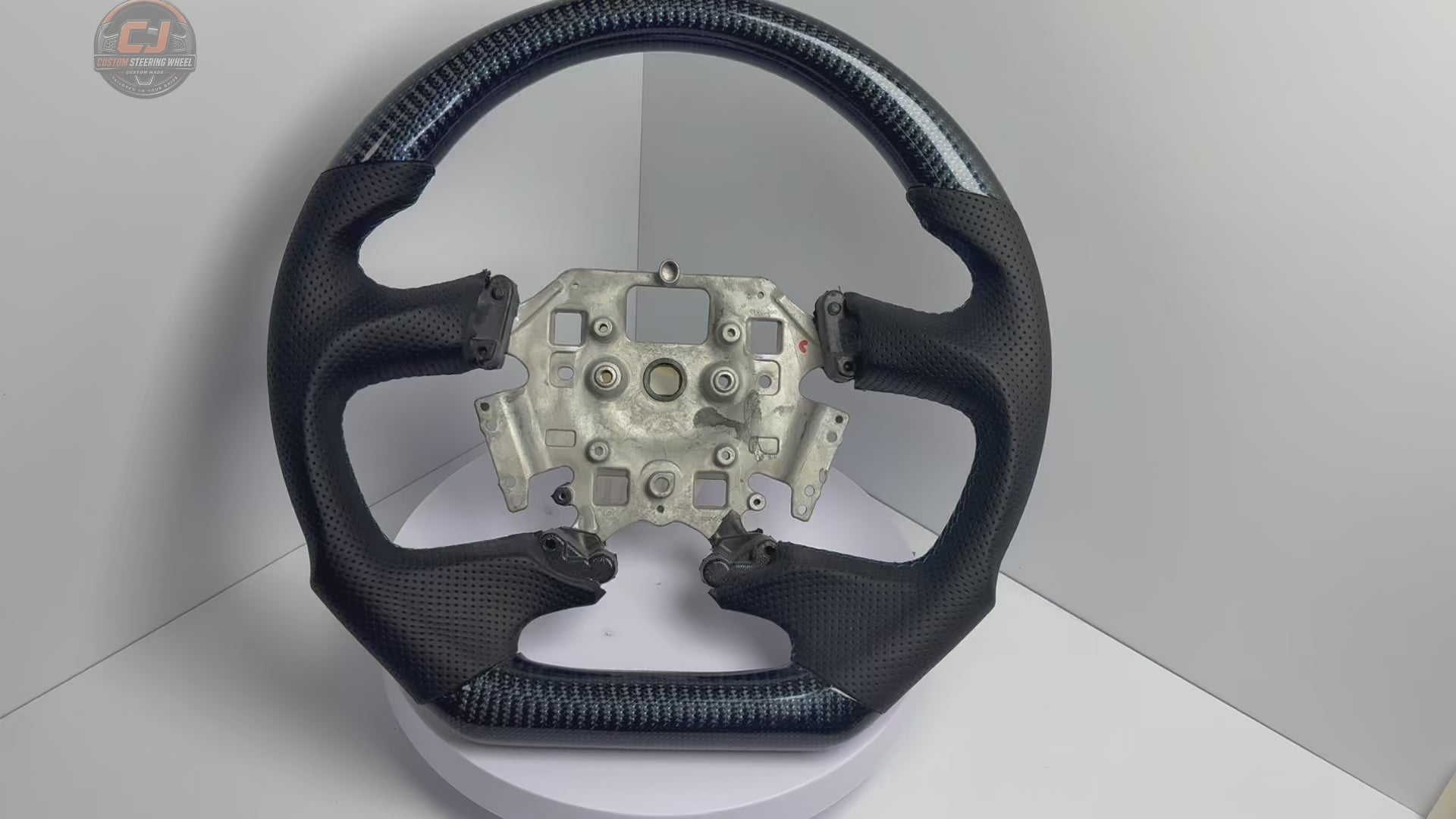 White background product video of Ford Falcon FG XR XR6 XR8 custom steering wheel in blue carbon fiber black perforated leather by CJ Mod Garage