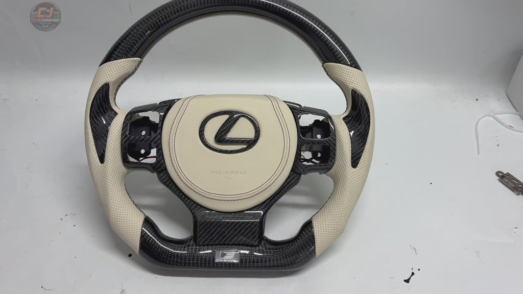 Lexus Custom Steering Wheel Product Video Highlighting Carbon Fiber Weave White Leather Airbag Cover Flat Bottom Shape And Detailed Finish For Lexus IS 2014 2020 RC 2015 2020 GS 2013 2020 NX 2015 2021 CT 2014 2022 CJ Mod Garage