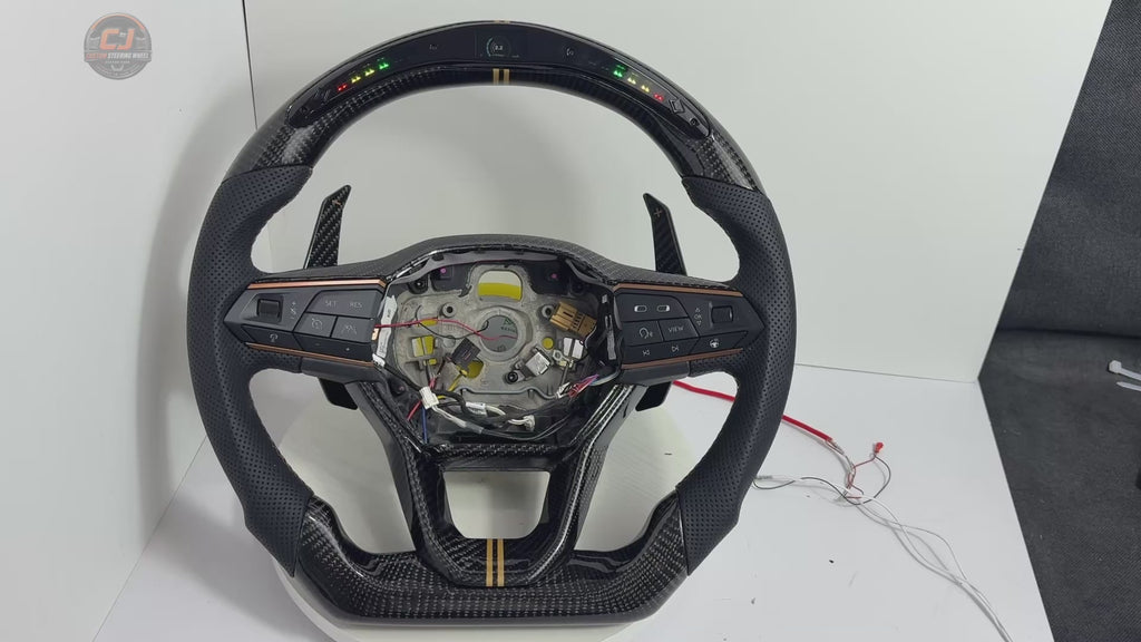 Showcase video of Seat Leon MK4 carbon fiber steering wheel highlighting LED shift light display perforated leather grip multifunction buttons paddle shifters and custom craftsmanship by CJ Mod Garage