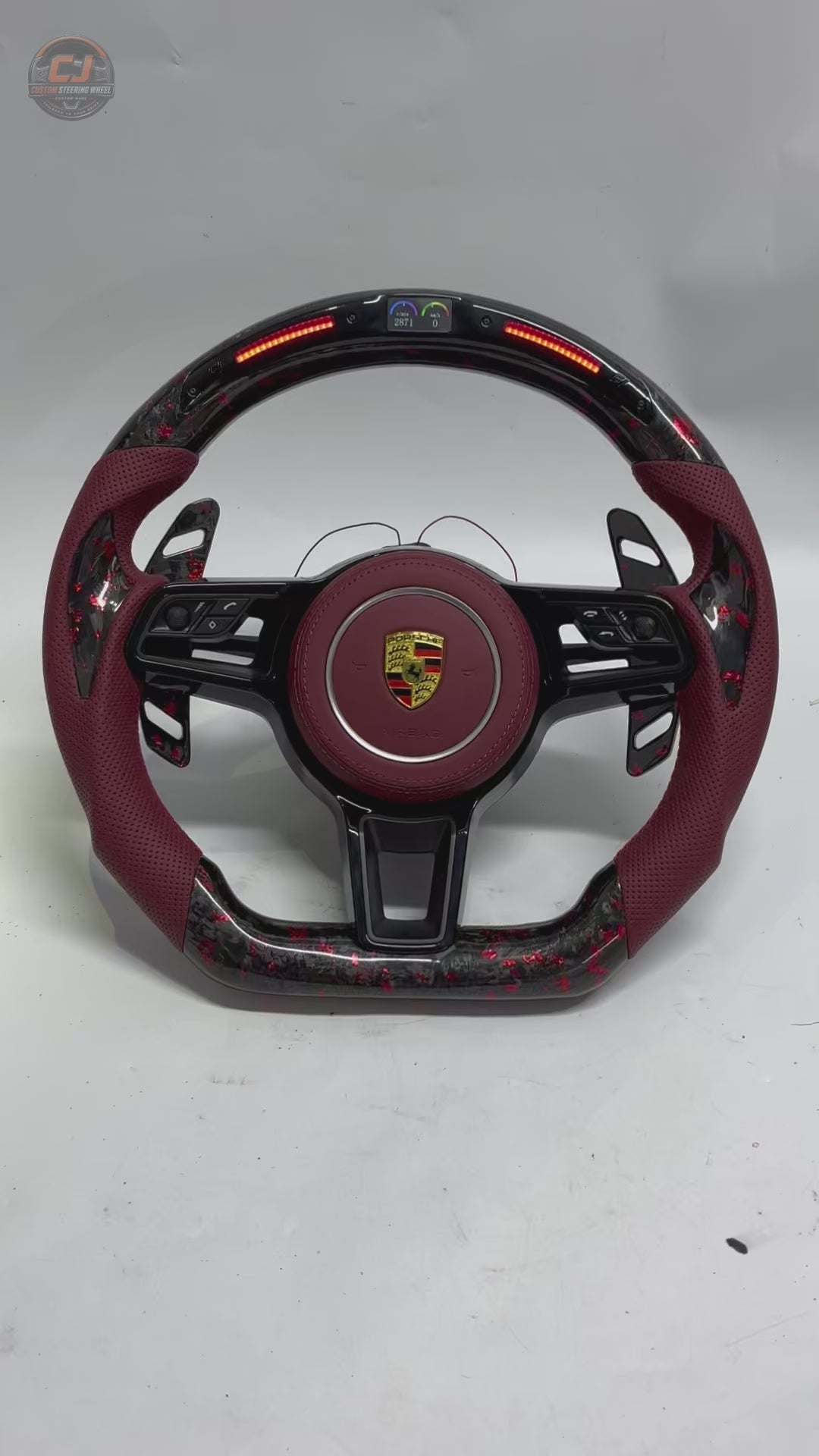 Porsche Forged Carbon Steering Wheel Video Showing Red Flake Carbon Finish Burgundy Leather Grip LED RPM Display and Custom Airbag Cover for Panamera Cayenne Macan Taycan Cayman Boxster CJ Mod Garage