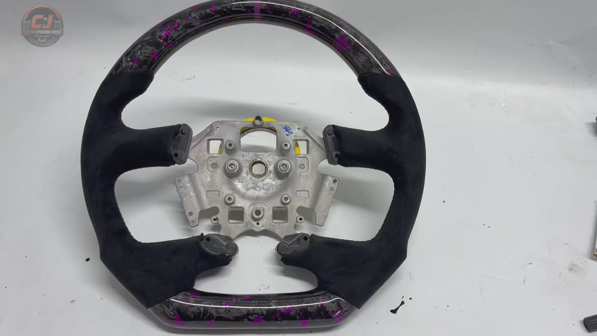 White background product video of Ford Falcon FG XR XR6 XR8 custom steering wheel in purple forged carbon and black suede grips by CJ Mod Garage