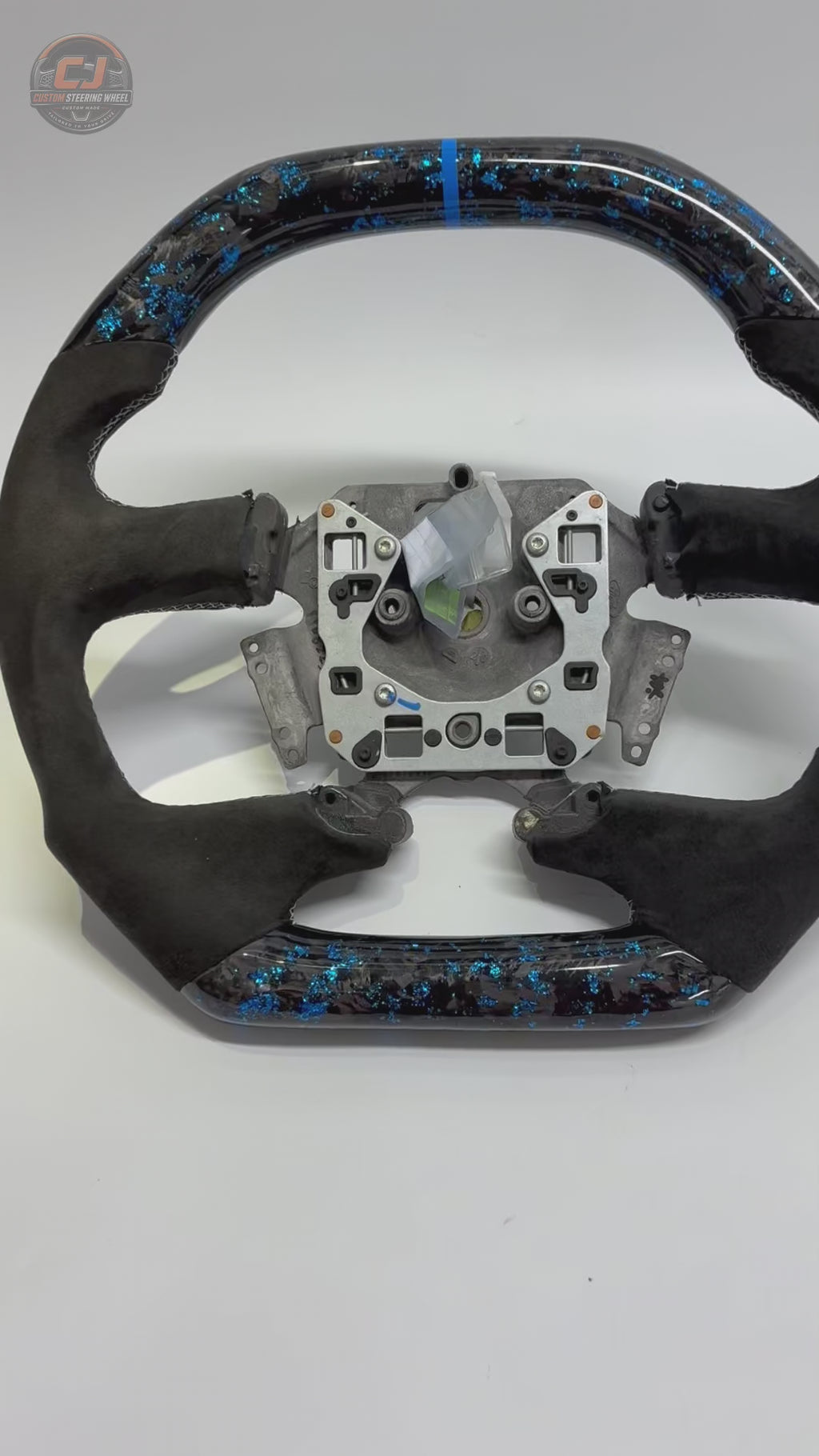 White background product video of Ford Falcon FG XR XR6 XR8 custom steering wheel in blue flake forged carbon blue center stripe and black Alcantara by CJ Mod Garage