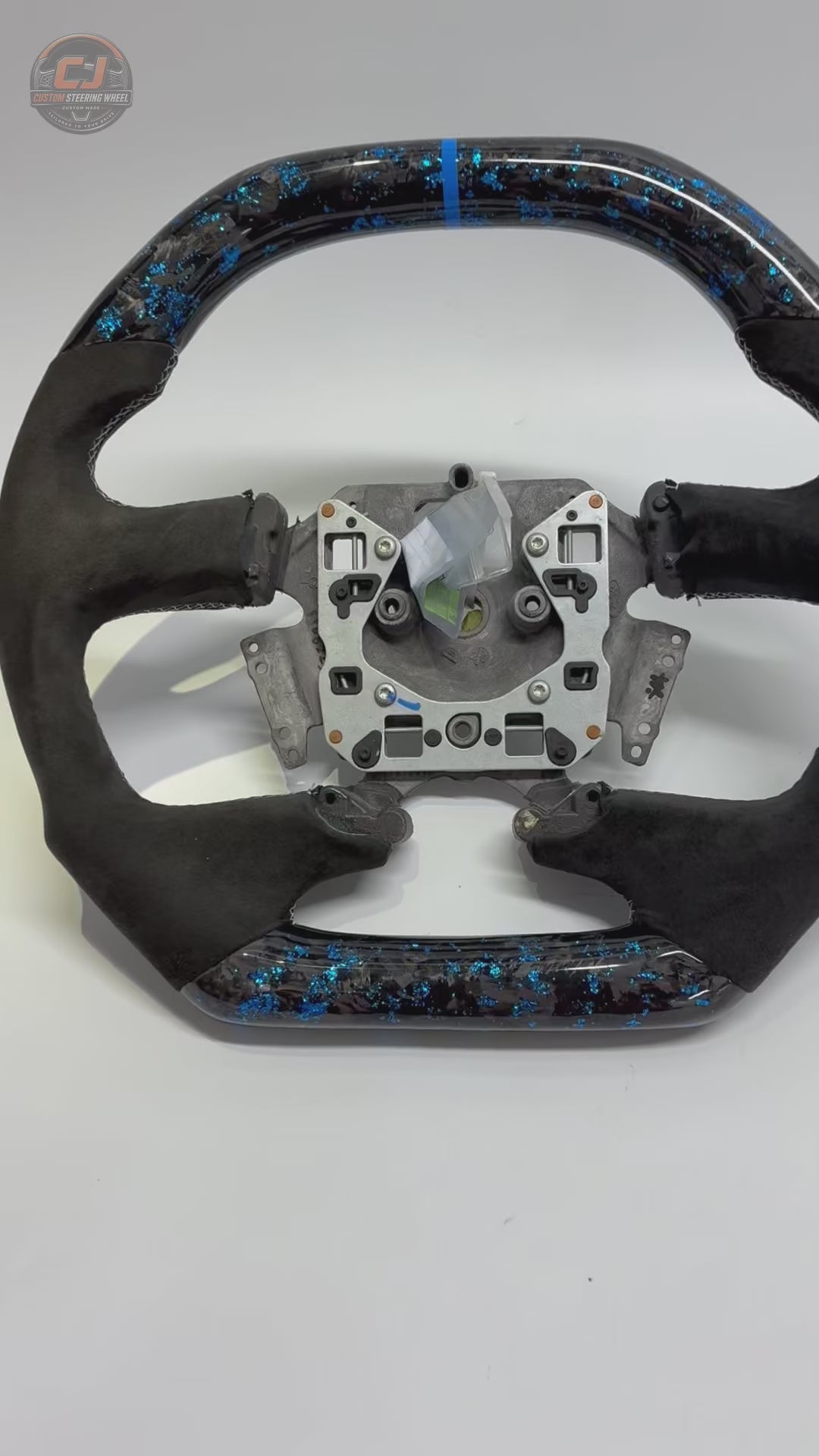 White background product video of Ford Falcon FG XR XR6 XR8 custom steering wheel in blue flake forged carbon blue center stripe and black Alcantara by CJ Mod Garage