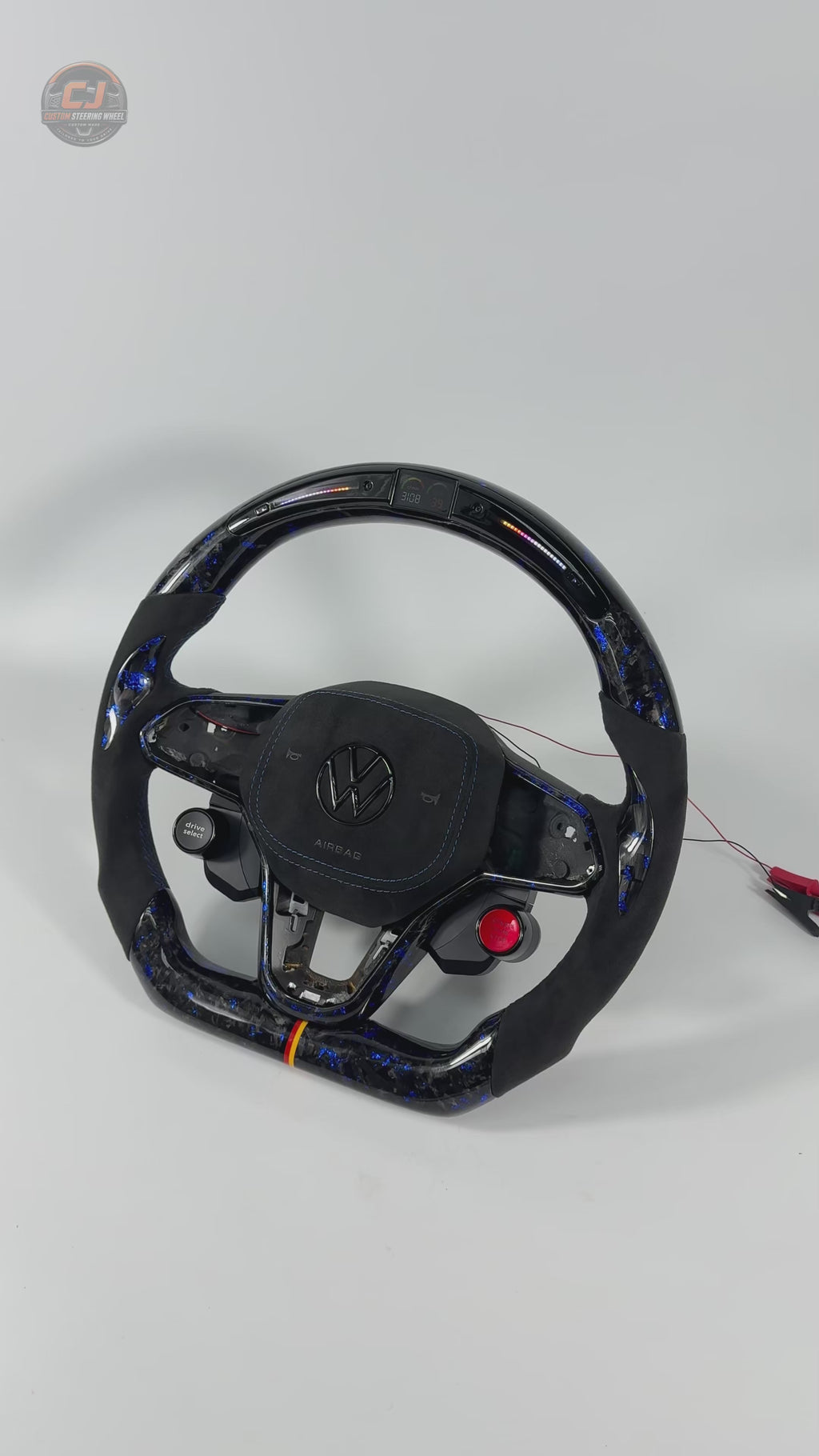 Studio showcase video featuring custom steering wheel with LED shift light display blue forged carbon styling Alcantara grips and performance inspired craftsmanship for Golf 8 MK8 Passat Touareg Tiguan Polo GTD MK7 MK6 R Line CC Jetta by CJ Mod Garage