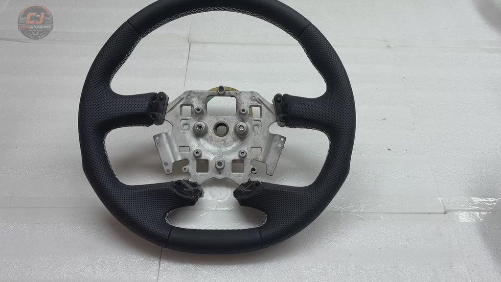 White background product video of Ford Falcon FG XR XR6 XR8 custom steering wheel in smooth black leather perforated grips and white stitching by CJ Mod Garage