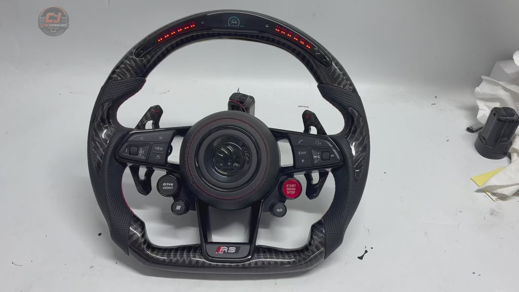 Studio video showcasing custom Skoda RS steering wheel with LED shift indicators carbon fiber detailing perforated leather sections and premium controls for Octavia RS 2014 ~2020 Superb 2015 ~2023 Kodiaq 2017~ 2024 by CJ Mod Garage