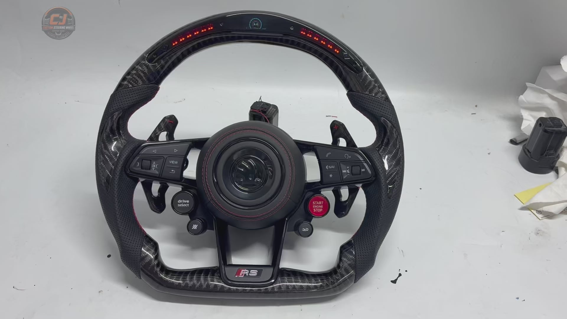 Studio video showcasing custom Skoda RS steering wheel with LED shift indicators carbon fiber detailing perforated leather sections and premium controls for Octavia RS 2014 ~2020 Superb 2015 ~2023 Kodiaq 2017~ 2024 by CJ Mod Garage