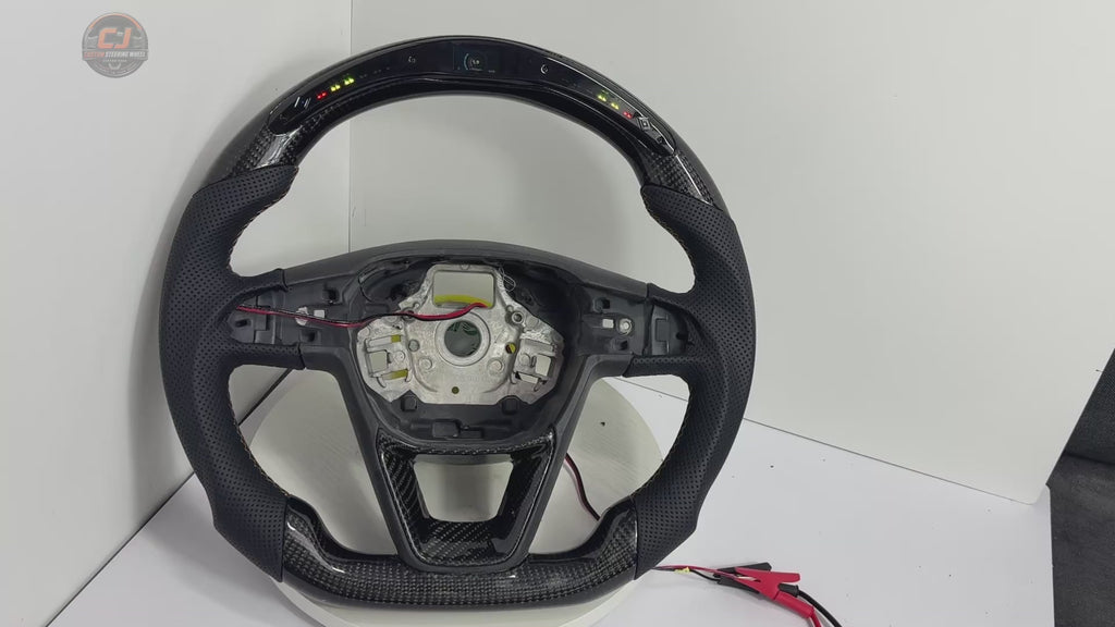 Product video showing Seat Leon Cupra carbon fiber steering wheel with LED shift light display perforated leather grips sport flat bottom shape and custom craftsmanship by CJ Mod Garage