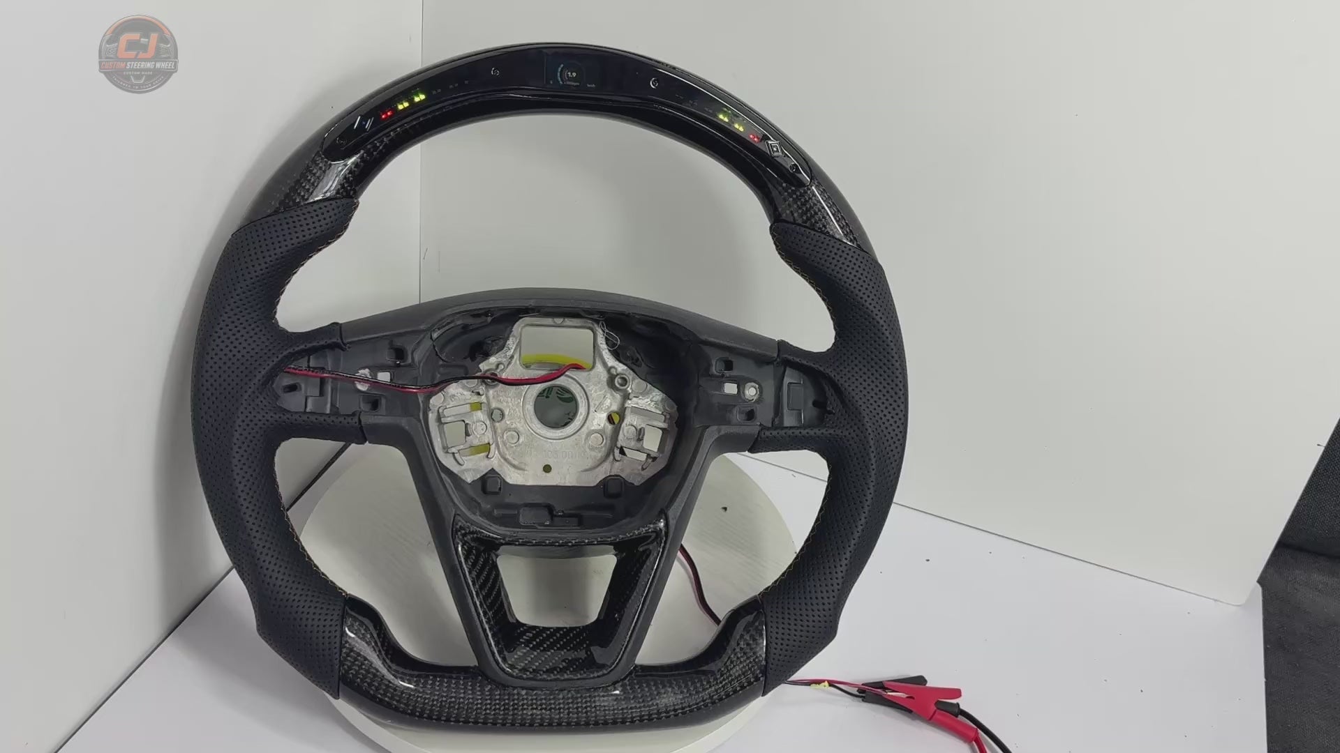Product video showing Seat Leon Cupra carbon fiber steering wheel with LED shift light display perforated leather grips sport flat bottom shape and custom craftsmanship by CJ Mod Garage