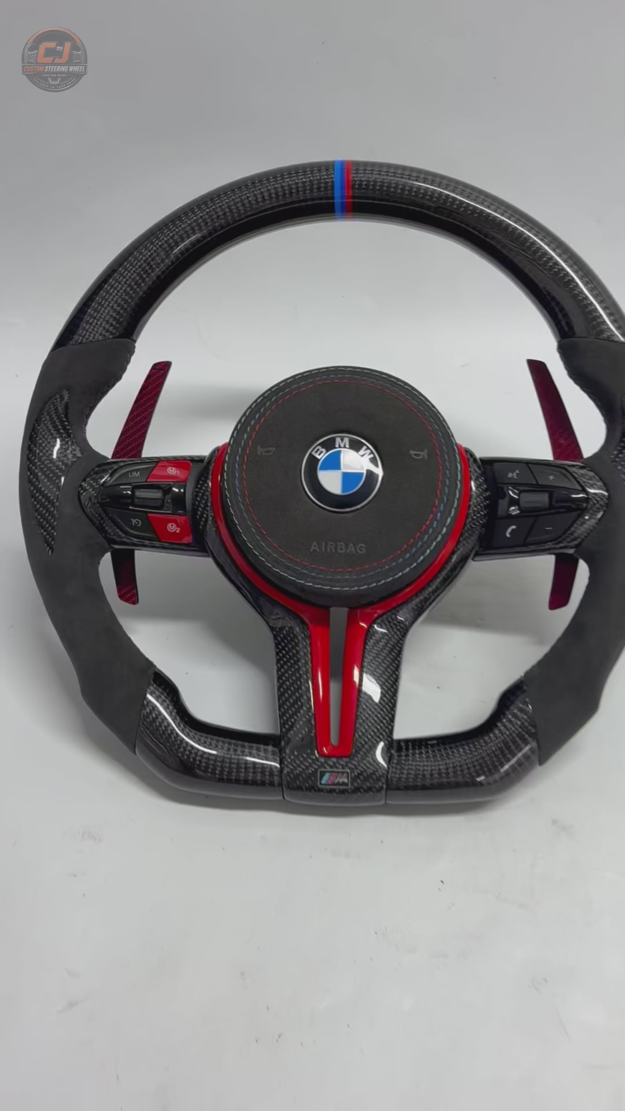 BMW F30 F32 F80 carbon fiber steering wheel with red sport accents, Alcantara side grips, and carbon paddle shifters