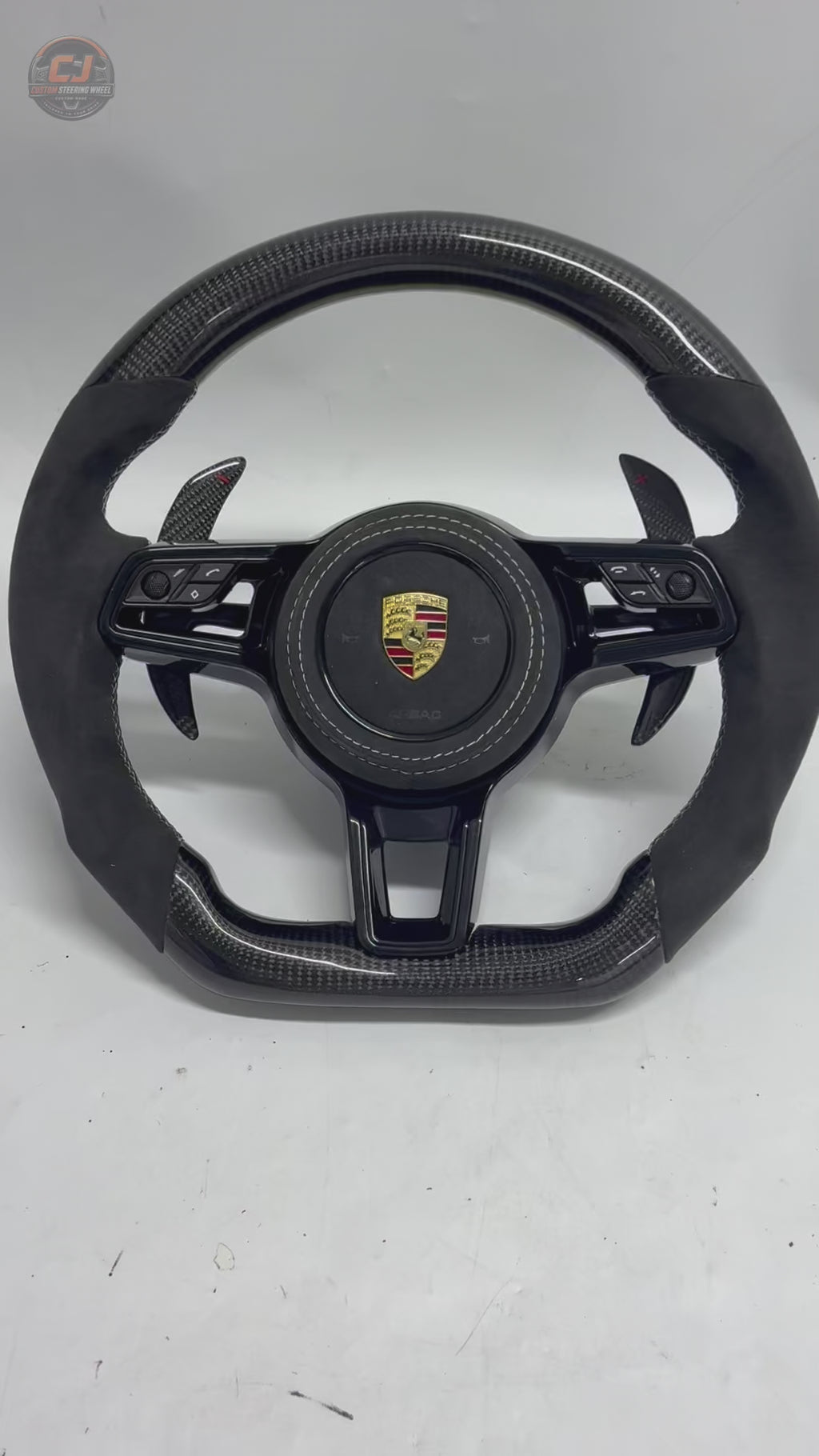 Porsche Carbon Fiber Alcantara Steering Wheel Product Video Showing Carbon Weave Alcantara Grip White Stitching and Paddle Shifters for Panamera 970 971 Cayenne 958 Macan 95B Taycan Cayman Boxster Carrera 911 CJ Mod Garage