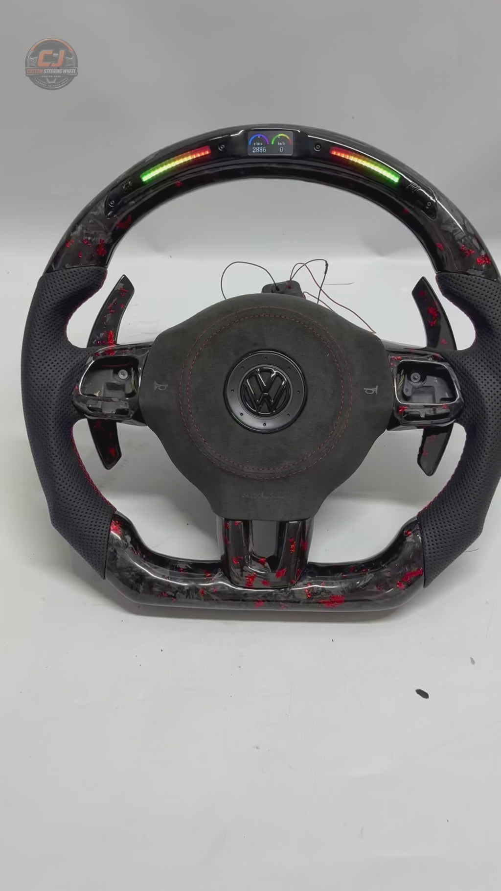 Rotating product video showing forged carbon red flake steering wheel with LED shift light display paddle shifters and perforated leather grips for Golf 6 MK6 Polo GTD MK7 R Line CC Jetta by CJ Mod Garage