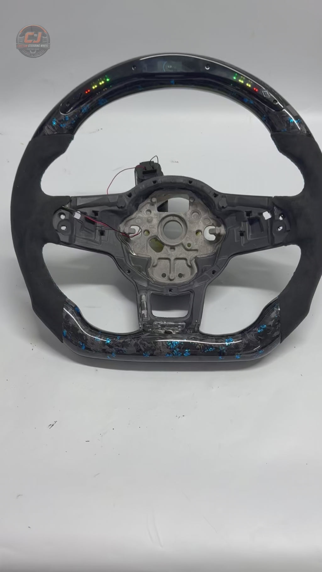 Volkswagen Golf GTI white studio product video showing blue forged carbon LED wheel shell details CJ Mod Garage