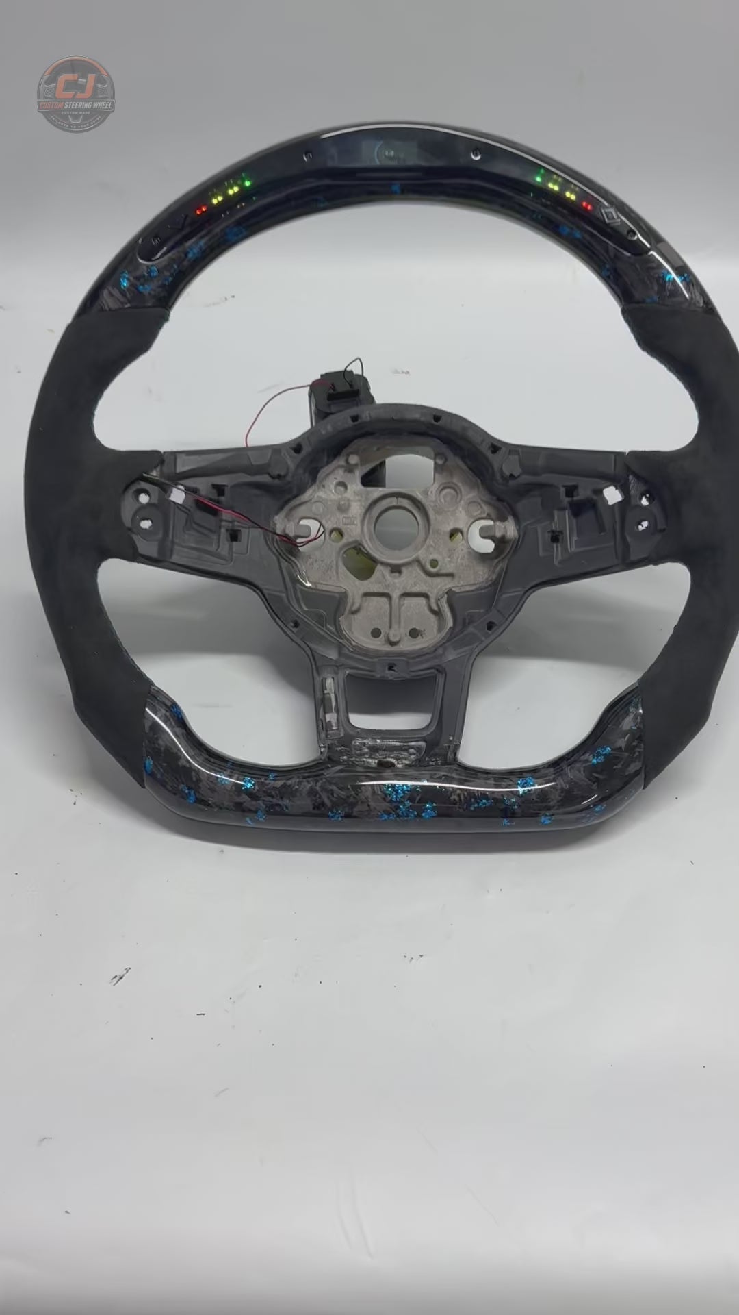 Volkswagen Golf GTI white studio product video showing blue forged carbon LED wheel shell details CJ Mod Garage