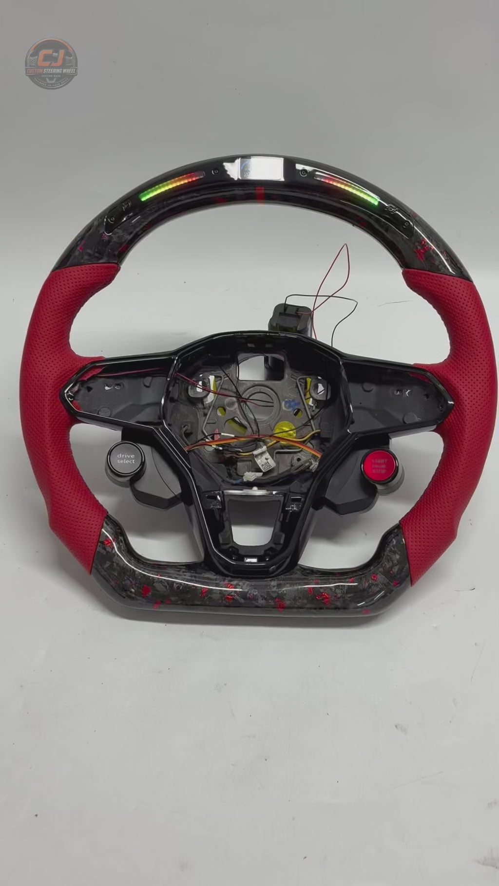 Studio product video showcasing forged carbon steering wheel with LED RPM display red perforated leather grips and performance styling for Golf 8 MK8 Passat Touareg Tiguan Polo GTD MK7 MK6 R Line CC Jetta by CJ Mod Garage