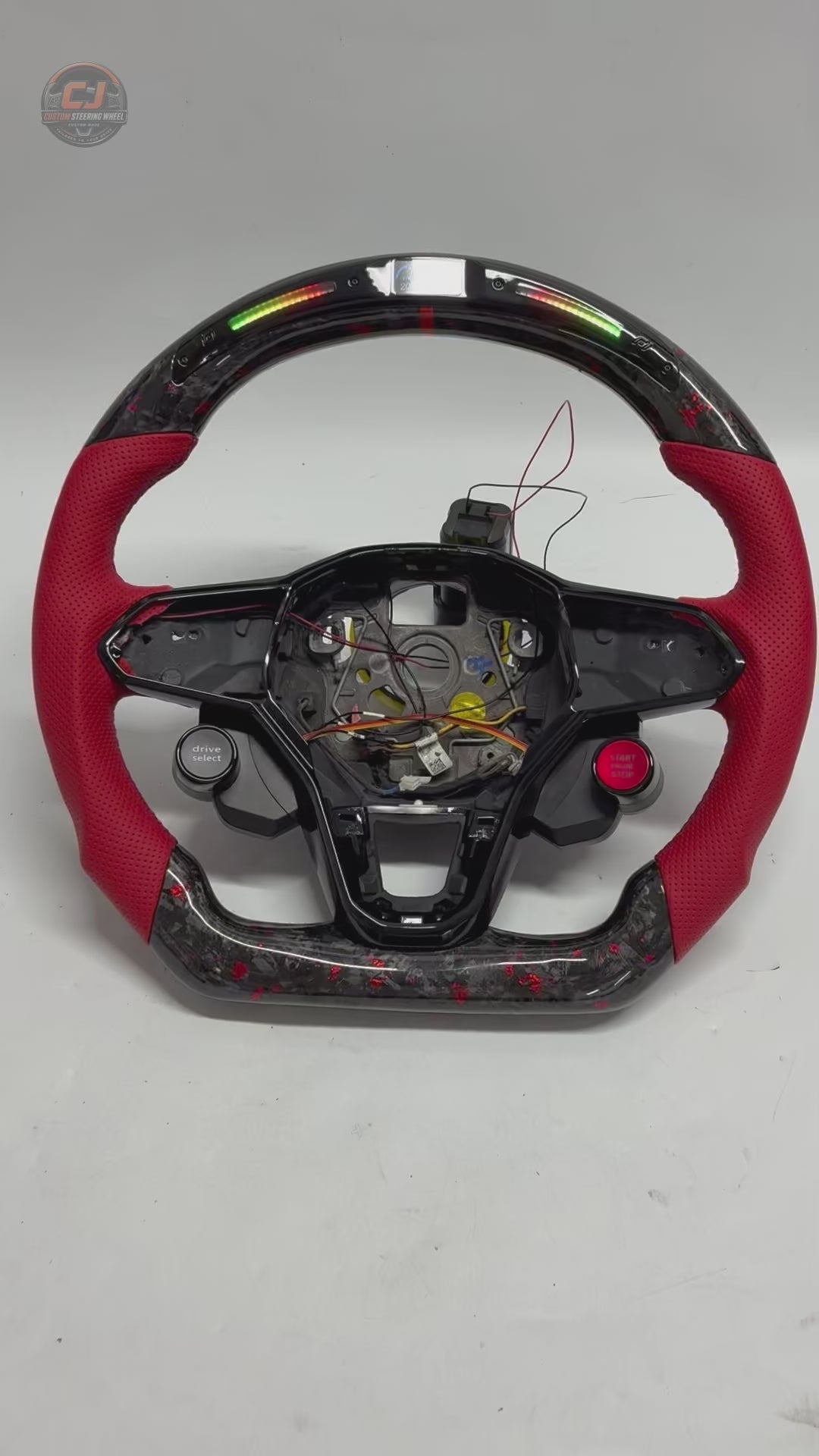 Studio product video showcasing forged carbon steering wheel with LED RPM display red perforated leather grips and performance styling for Golf 8 MK8 Passat Touareg Tiguan Polo GTD MK7 MK6 R Line CC Jetta by CJ Mod Garage