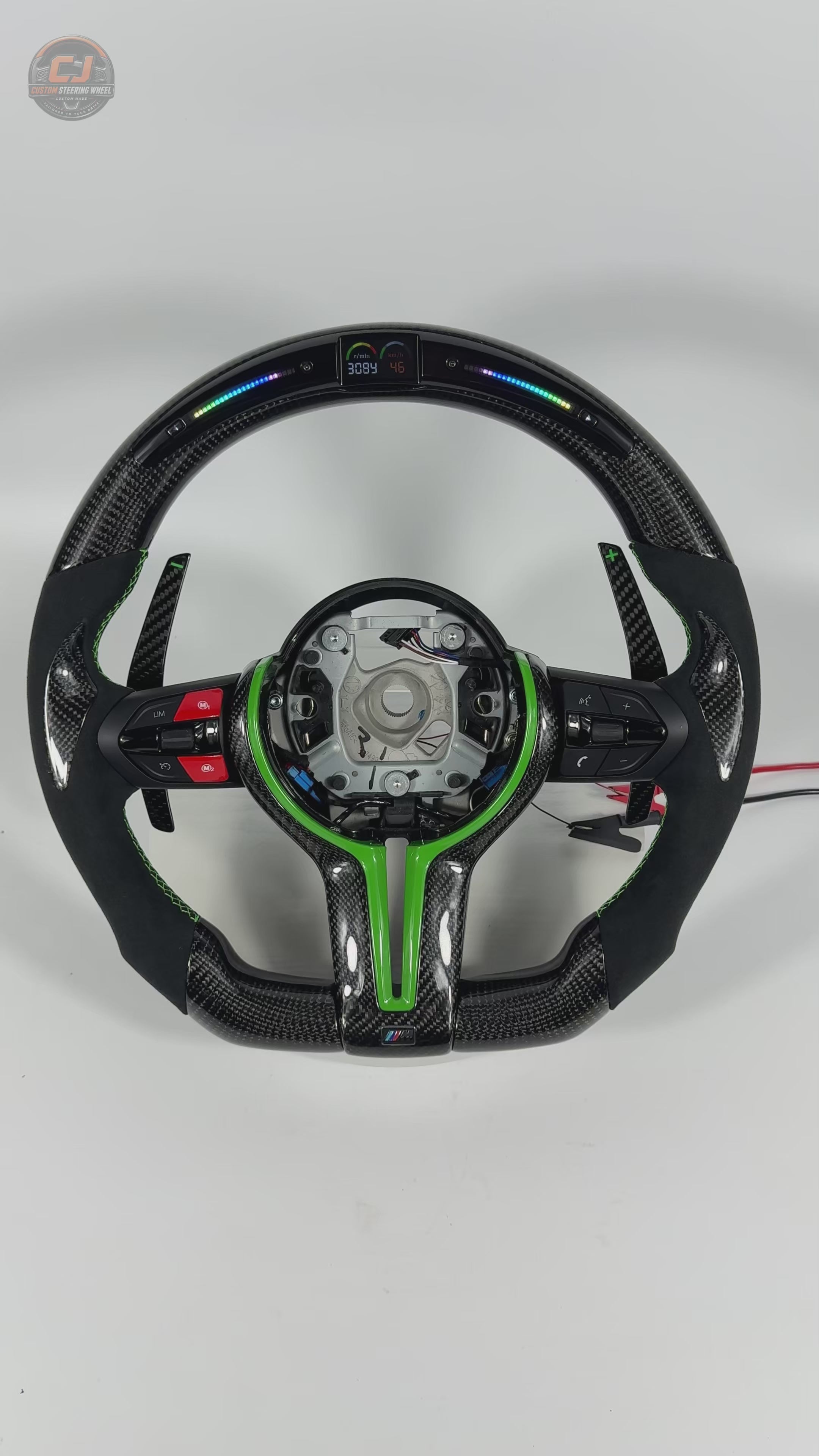 White background product showcase video of custom BMW carbon fiber steering wheel with green trim, Alcantara suede grips, LED shift lights, multifunction buttons, and paddle shifters for BMW F10 F11 F15 F18 F20 F23 F25 F30 F32 F35 F40 F80 E84 E87 E90 E92 E93