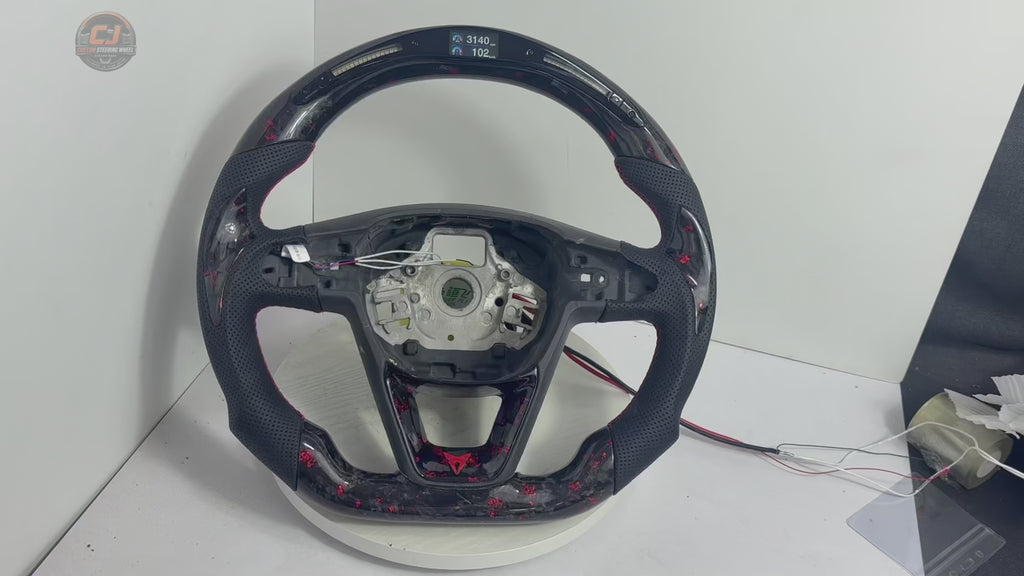 Product showcase video of Seat Leon Cupra forged carbon fiber steering wheel with red flake carbon finish LED shift light display perforated leather grips and custom flat bottom construction by CJ Mod Garage