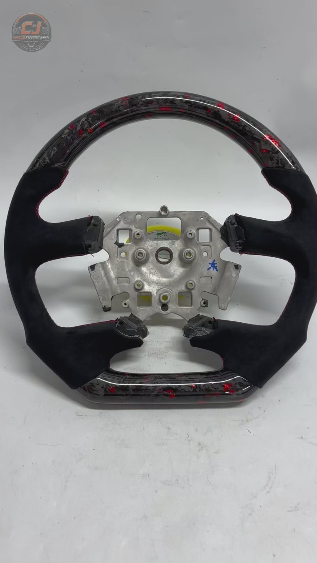 White background product video of Ford Falcon FG XR XR6 XR8 custom steering wheel in red flake forged carbon black Alcantara by CJ Mod Garage