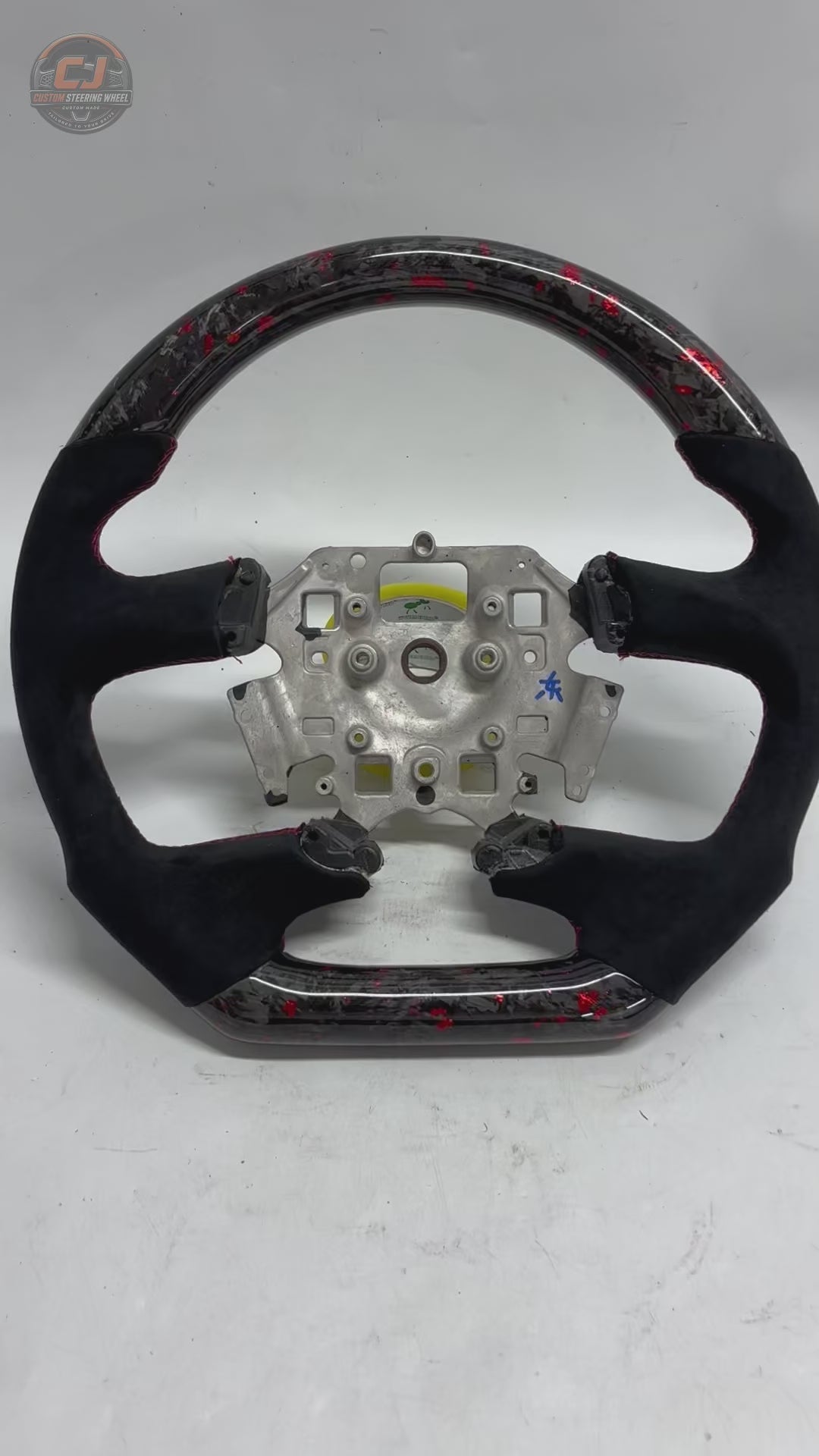 White background product video of Ford Falcon FG XR XR6 XR8 custom steering wheel in red flake forged carbon black Alcantara by CJ Mod Garage