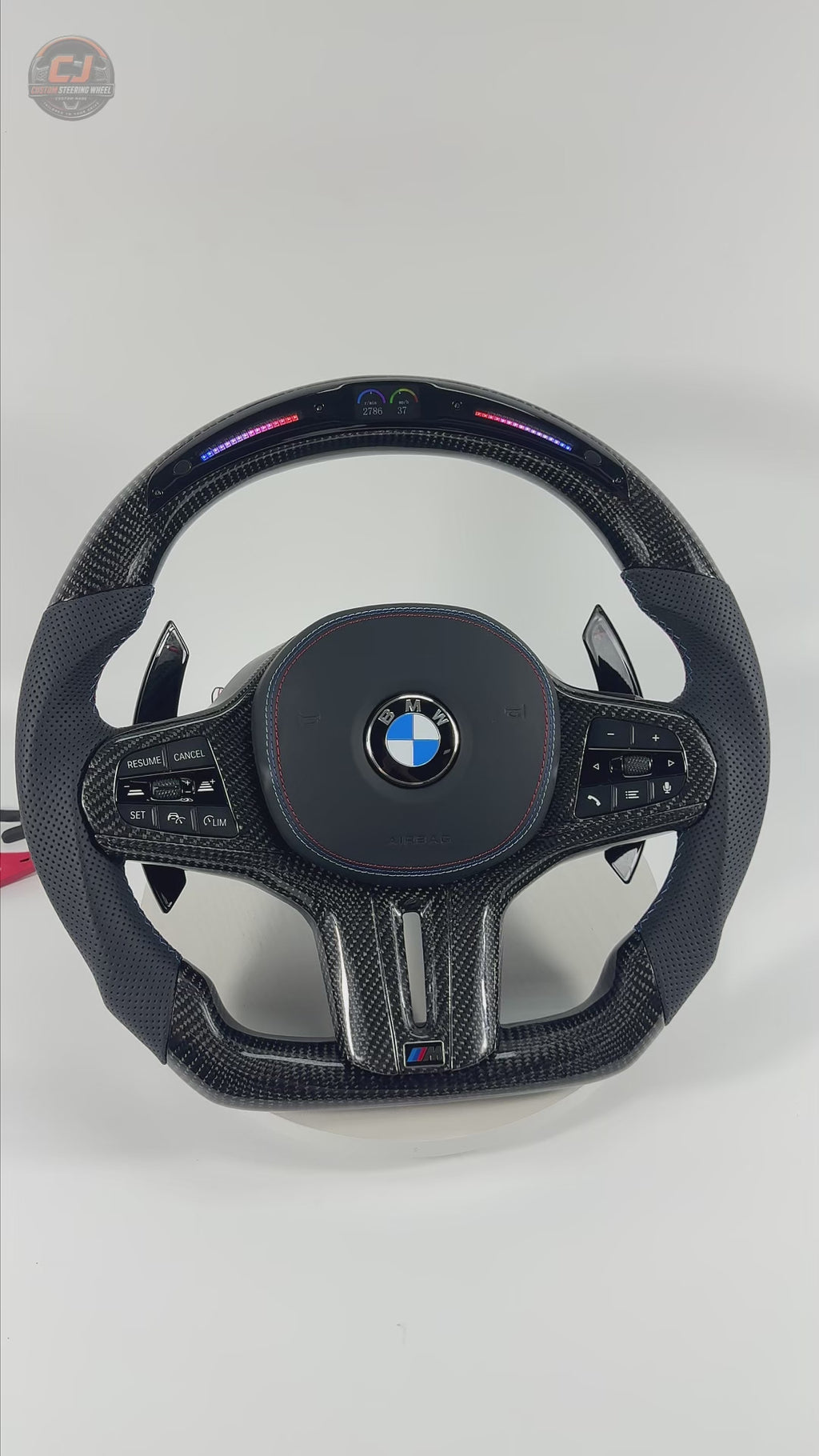 White background product video showcasing BMW custom LED steering wheel with glossy carbon fiber, perforated leather grips and racing-inspired contour for BMW G02 G05 G06 G09 G11 G12 G15 G20 G22 G28 G29 G30 G38 G80 G82 F40 F90 by CJ Mod Garage