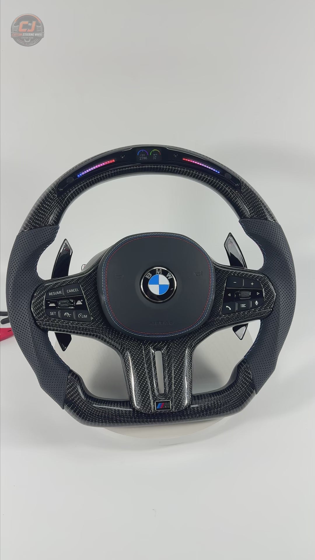 White background product video showcasing BMW custom LED steering wheel with glossy carbon fiber, perforated leather grips and racing-inspired contour for BMW G02 G05 G06 G09 G11 G12 G15 G20 G22 G28 G29 G30 G38 G80 G82 F40 F90 by CJ Mod Garage