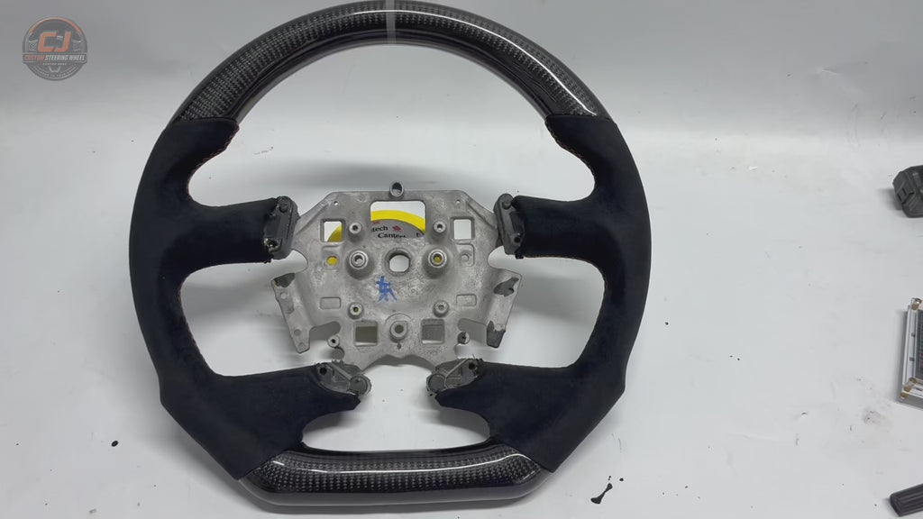 White background product video of Ford Falcon FG XR XR6 XR8 custom steering wheel in carbon fiber black suede grips and orange stitching by CJ Mod Garage