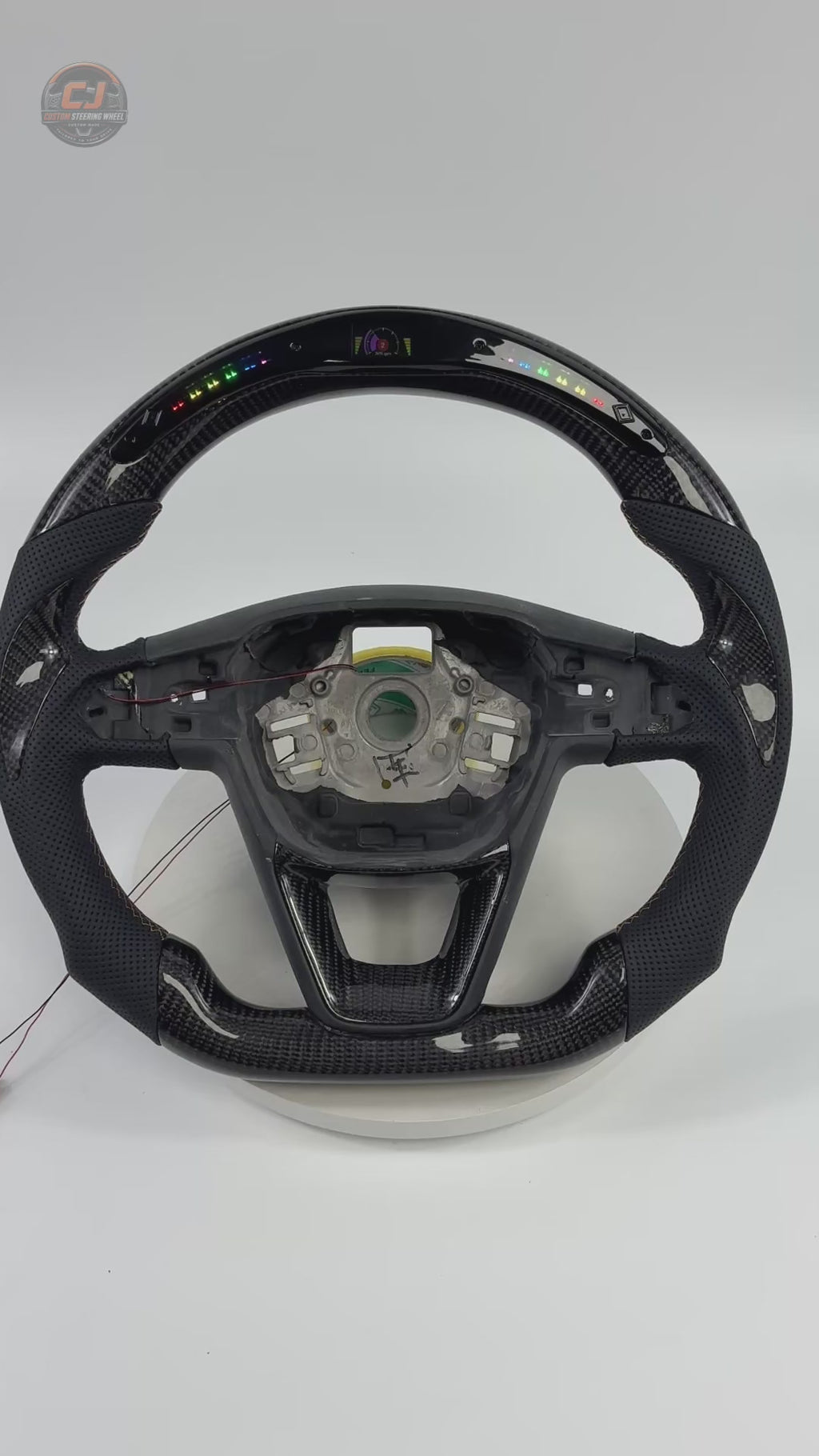 Showcase video of Seat Leon MK4 carbon fiber steering wheel highlighting LED shift light display perforated leather grip multifunction buttons paddle shifters and custom craftsmanship by CJ Mod Garage