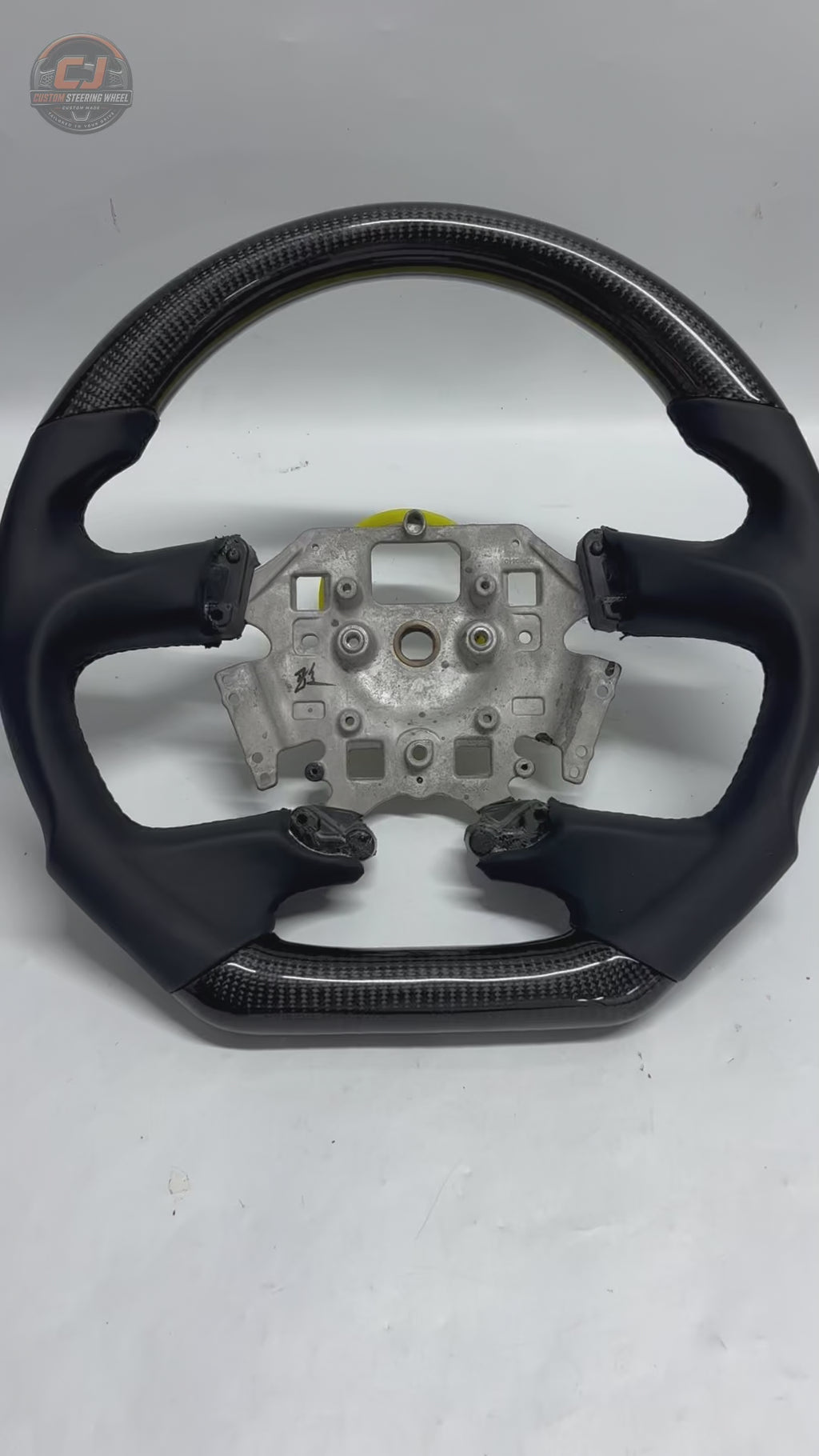 360-degree product video of a Ford Falcon FG XR6 XR8 custom carbon fiber steering wheel showcasing glossy carbon weave, smooth leather grips, flat-bottom styling and handcrafted detailing by CJ Mod Garage