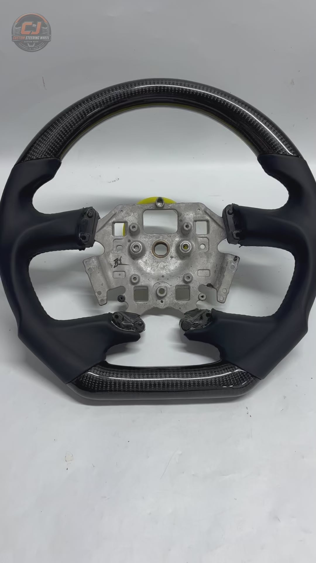 360-degree product video of a Ford Falcon FG XR6 XR8 custom carbon fiber steering wheel showcasing glossy carbon weave, smooth leather grips, flat-bottom styling and handcrafted detailing by CJ Mod Garage