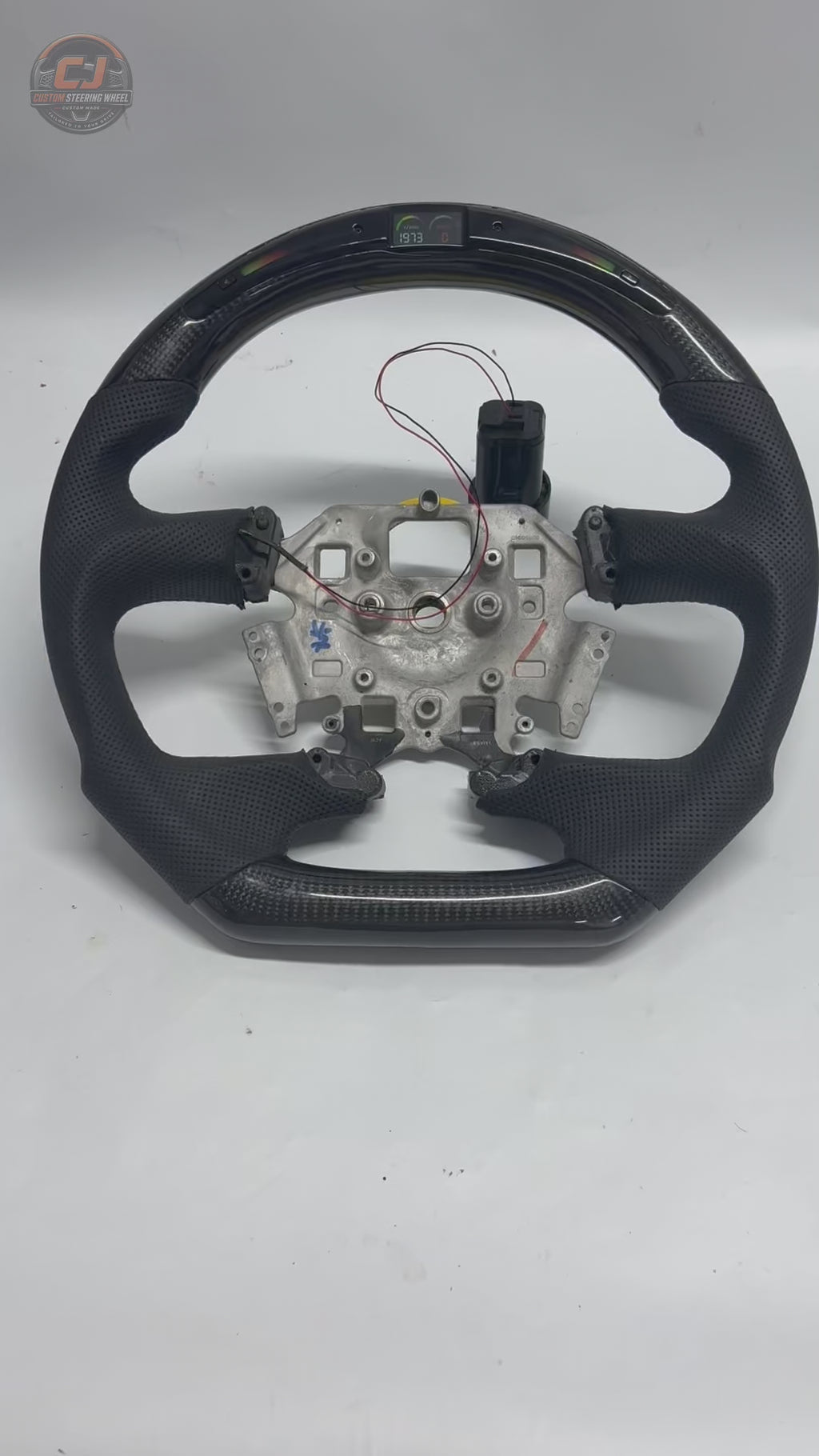 Ford Falcon FG XR XR6 XR8 LED custom steering wheel video on white background with carbon fiber and black perforated leather by CJ Mod Garage